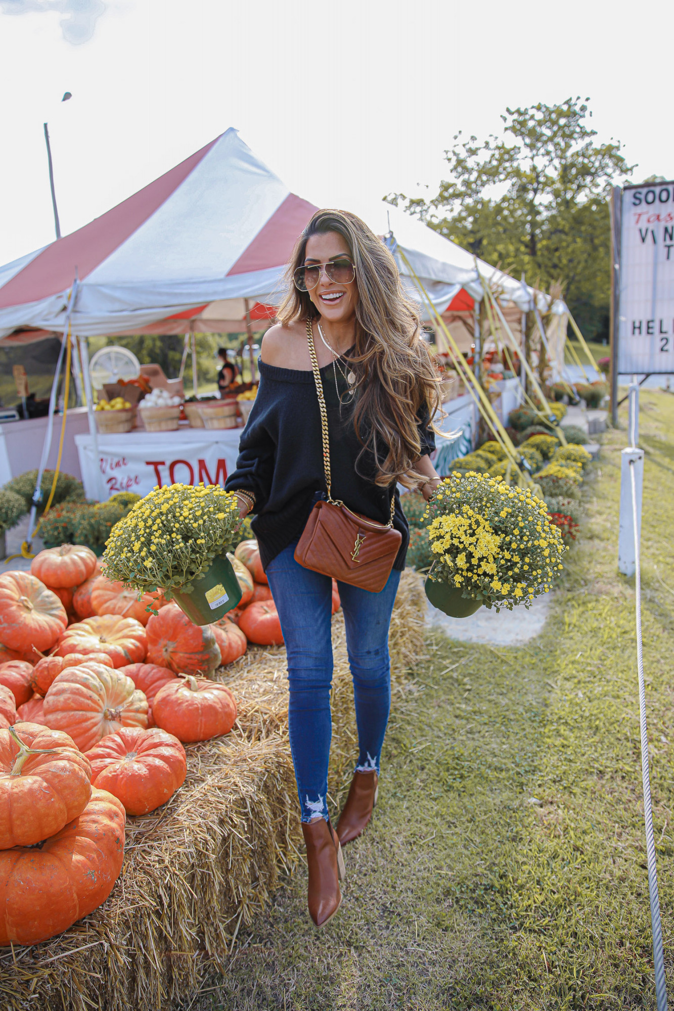 fall fashion 2020 pumpkin patch mums, free people fall fashion 2020 nordstrom, emily anng gemma |Instagram Recap by popular US lifestyle blog, The Sweetest Thing: image of Emily Gemma wearing a Free People black sweater, Good American Jeans, YSL bag, 8 other reasons necklace, Bon Levy earrings, brown Steve Madden ankle boots, and Alexander McQueen sunglasses while standing next to a pile of pumpkins and potted mums. 