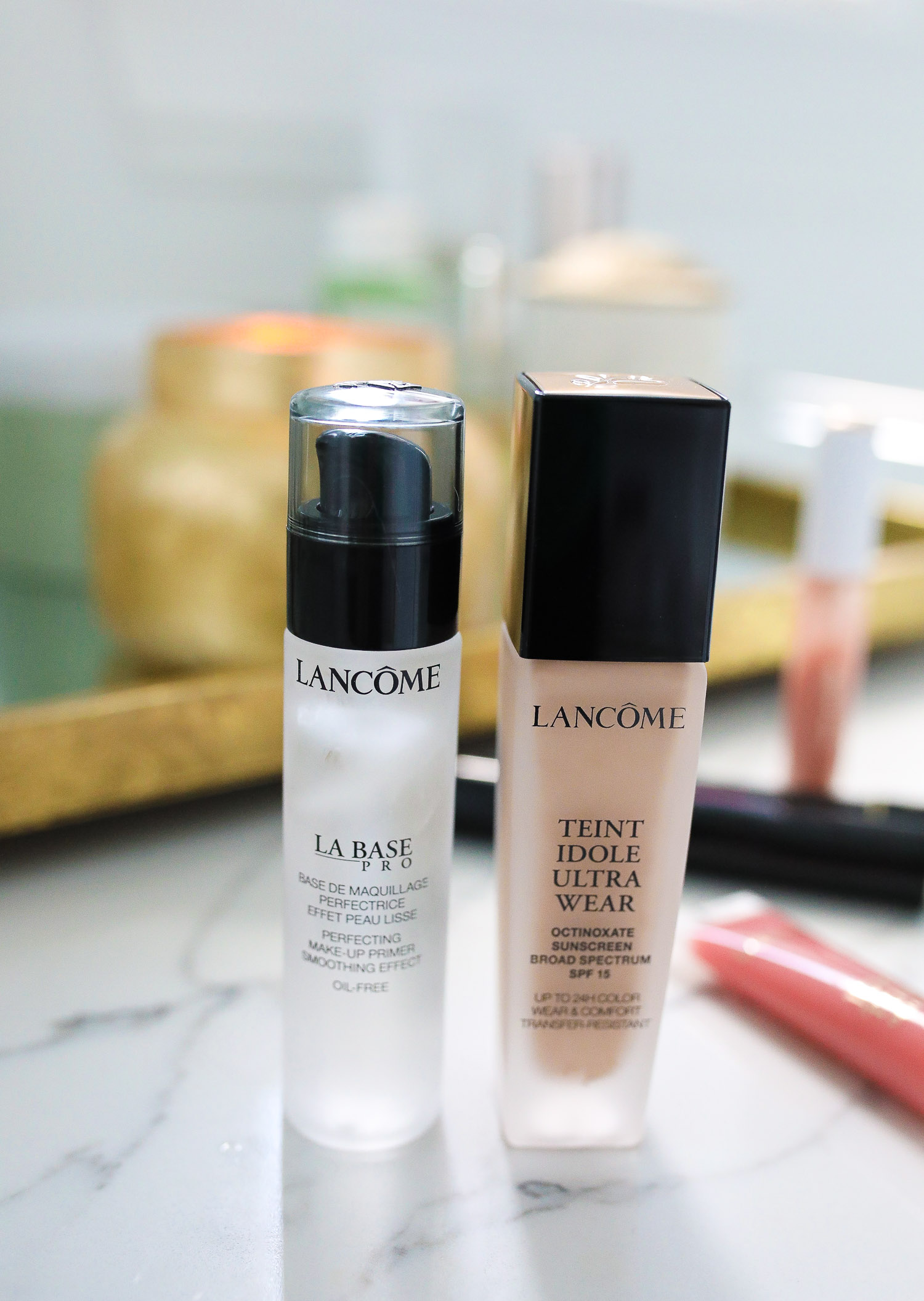 Lancôme Teint Idole Ultra Wear by popular US beauty blog, The Sweetest Thing: image of a bottle of Lancome Teint Idole Ultra Wear foundation next to a bottle of Lancome La Base pro. 