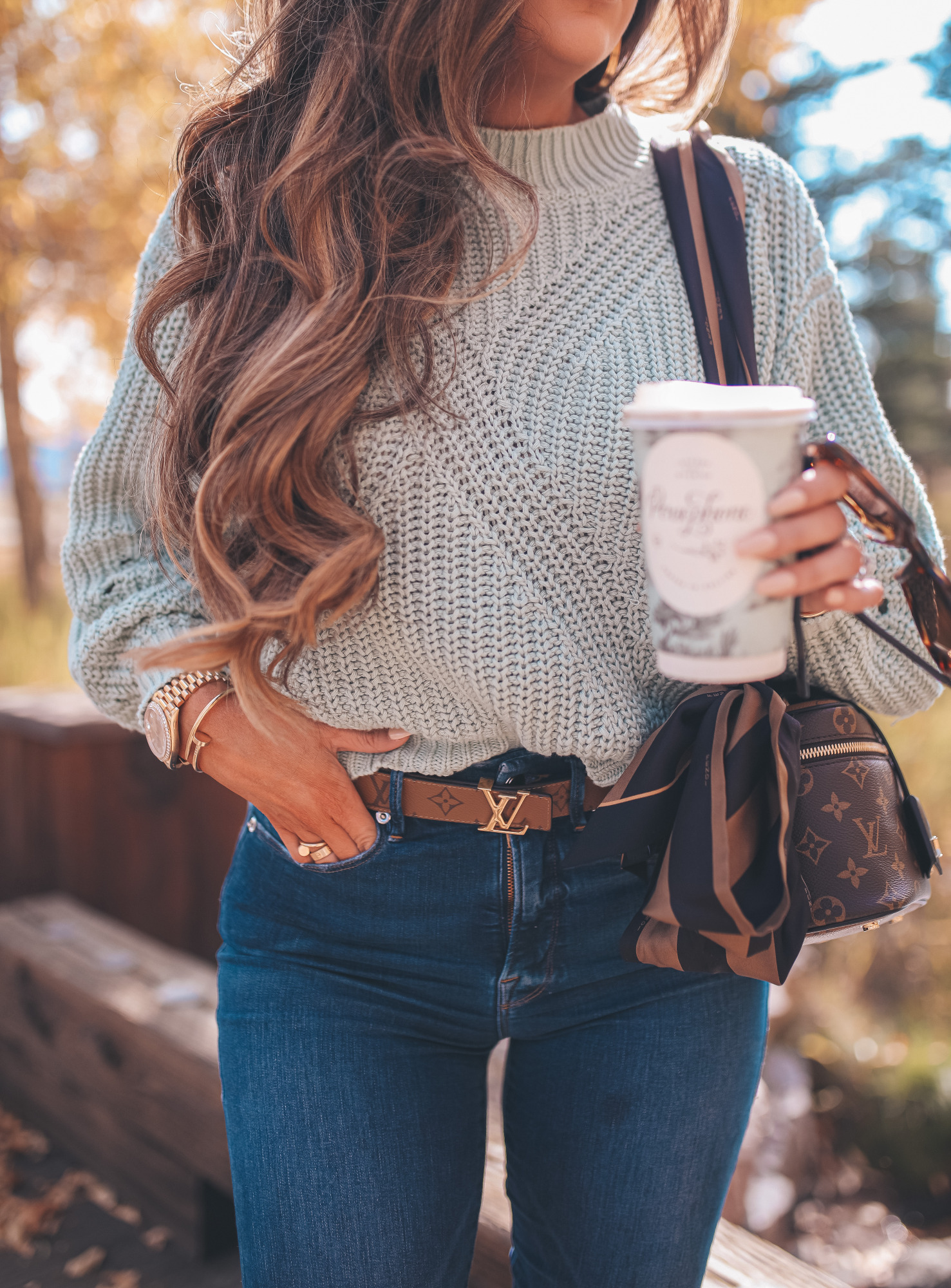 Fall Clothing by popular US fashion blog, The Sweetest Thing: image of Emily Gemma outside at Jackson Hole and wearing a Nordstrom BP.Traveling Stitch Sweater, Nordstrom Good American Good Waist Distressed High Waist Ankle Skinny Jeans, Nordstrom Steve Madden Kaylah Pointed Toe Bootie, and sitting next to a pair of Nordstrom Celine 54mm Cat Eye Sunglasses.