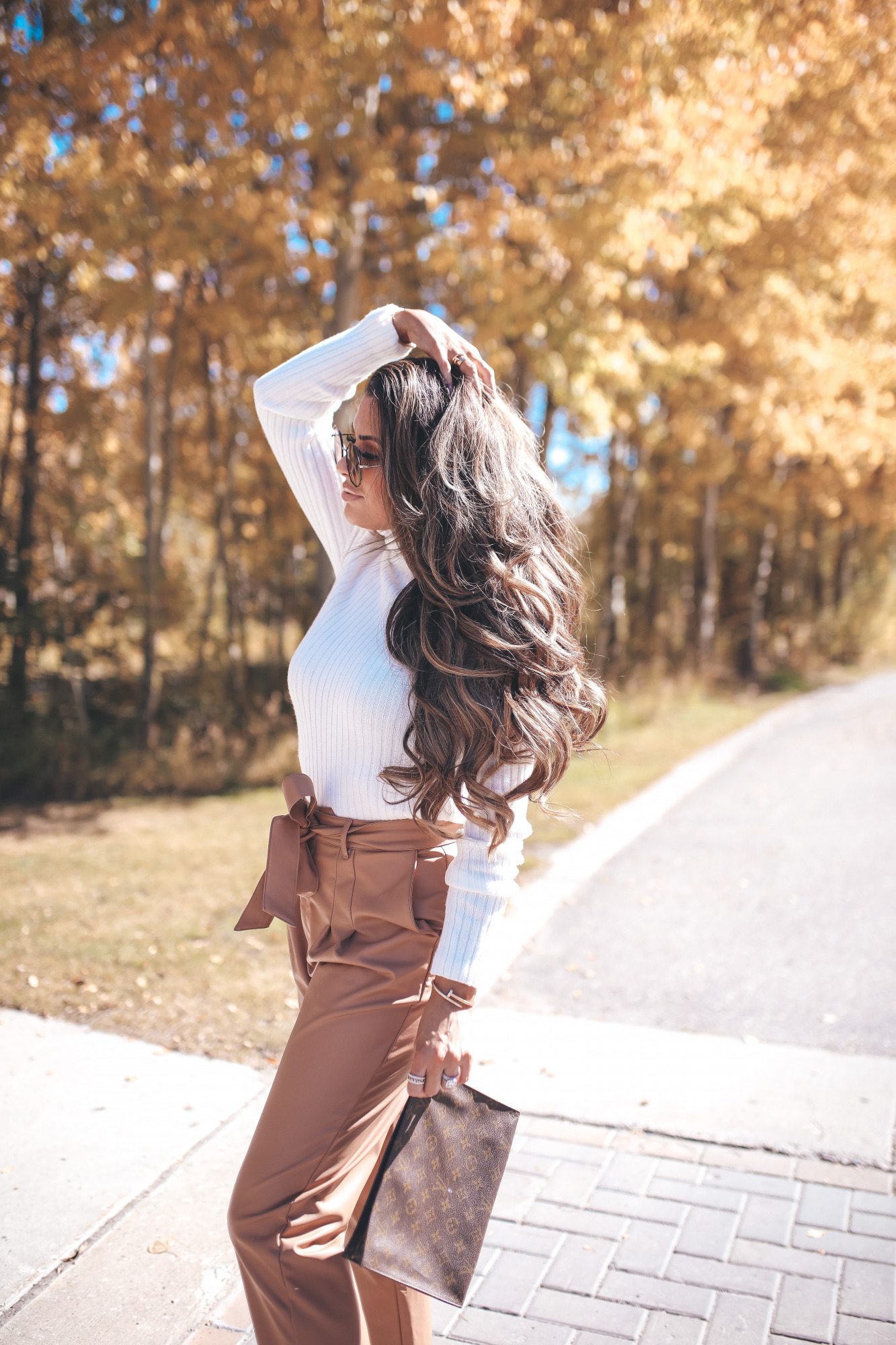 cute fall outfit idea dressy with booties, pinterest fall outfit ideas 2020, express fall outfits 2020JPG |Fall Outfits by popular US fashion blog, The Sweetest Thing: image of Emily Gemma outside in Jackson Hole and wearing a Express Wide Ribbed Turtleneck Sweater, Express Super High Waisted Vegan Leather Belted Ankle Pant, Express Snakeskin Textured Block Heel Booties, Express Small Twisted Hoop Earrings, and Express Octagon Cut-Out Sunglasses.