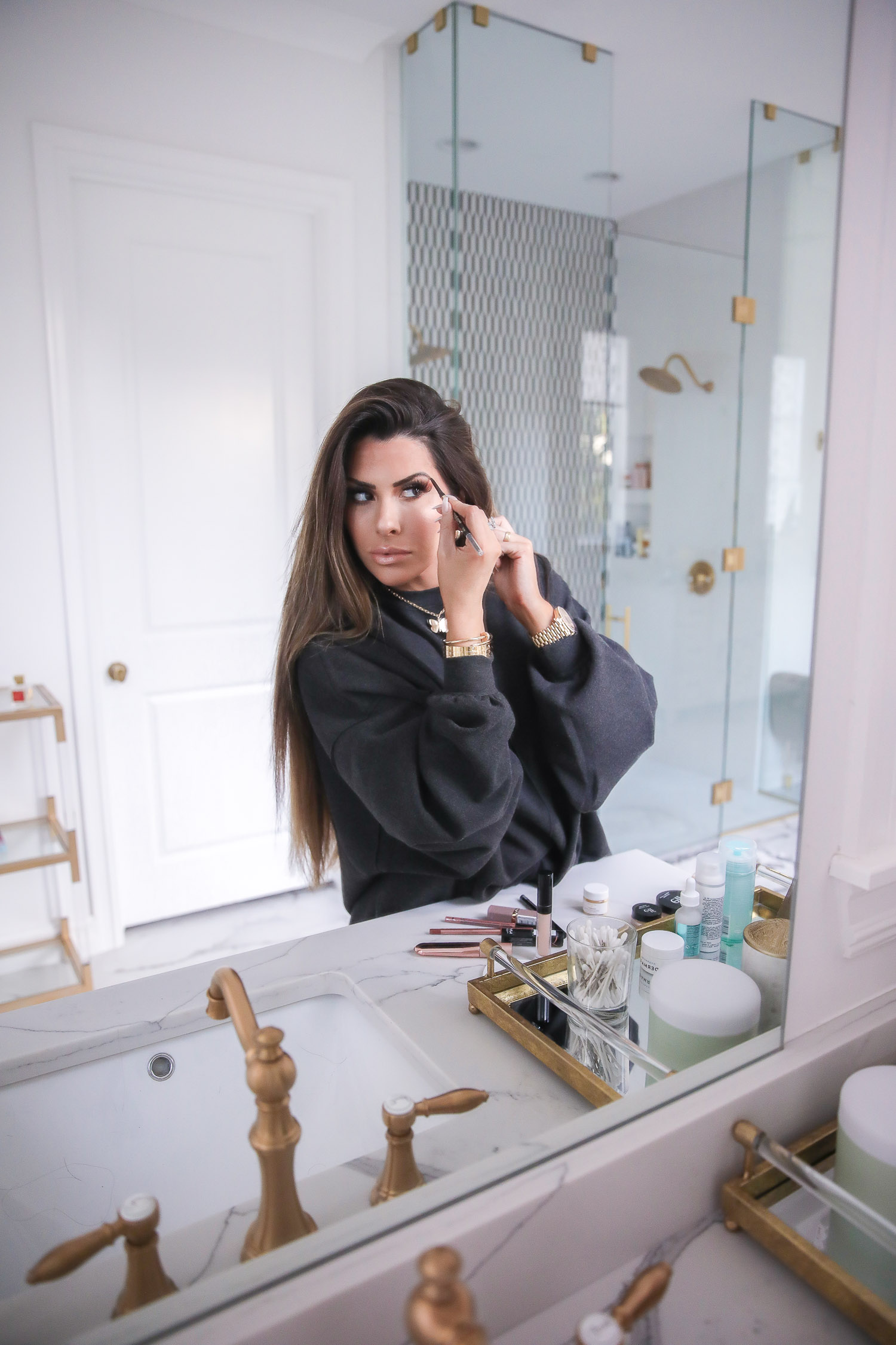 Drugstore Makeup by popular US beauty blog, The Sweetest Thing: image of Emily Gemma penciling in her eyebrow. 