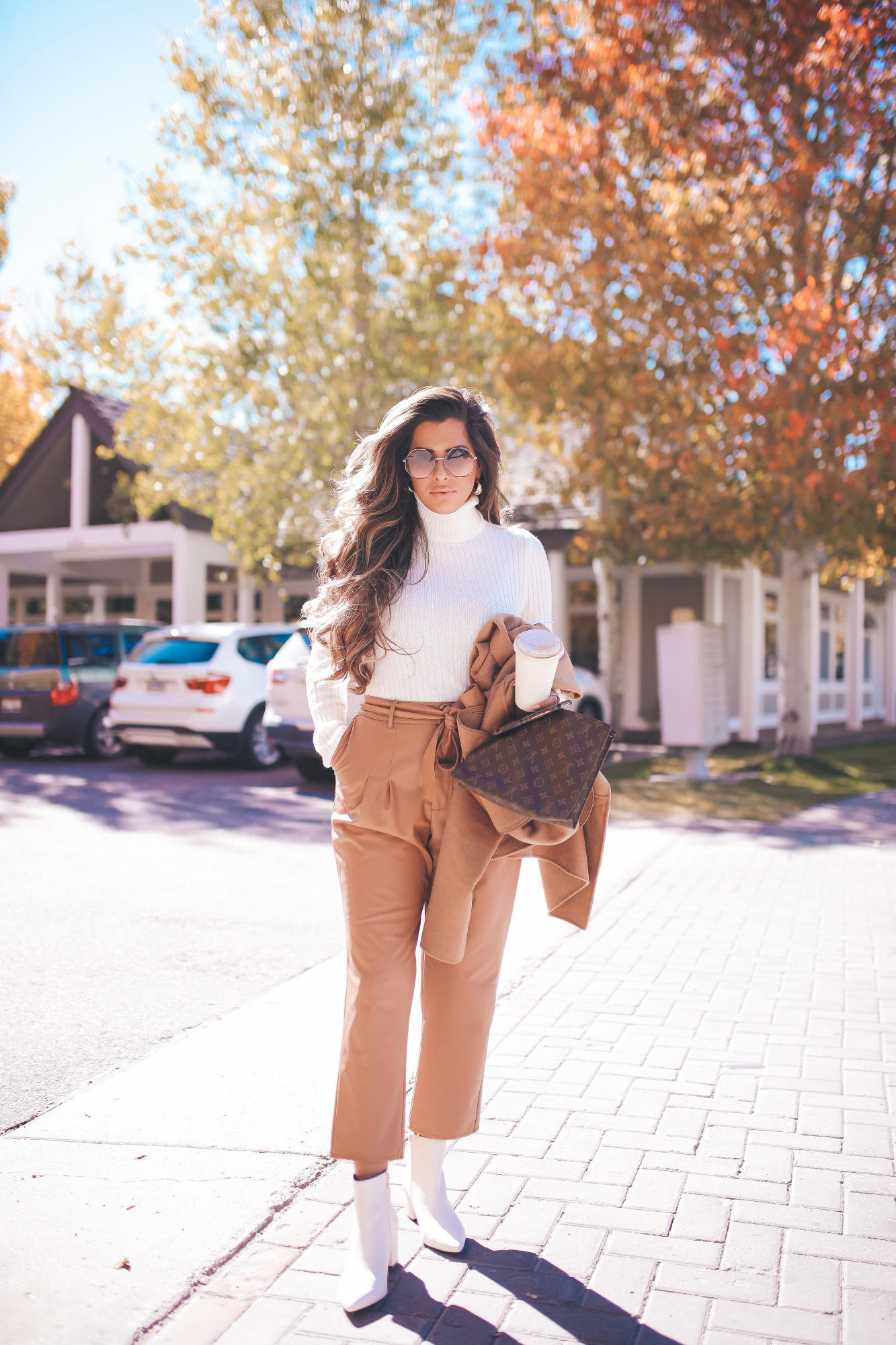 fall fashion outifit ideas pinterest 2020, fall fashion express 2020, fall outfits white booties, emily gemma |Fall Outfits by popular US fashion blog, The Sweetest Thing: image of Emily Gemma outside in Jackson Hole and wearing a Express Wide Ribbed Turtleneck Sweater, Express Super High Waisted Vegan Leather Belted Ankle Pant, Express Snakeskin Textured Block Heel Booties, Express Small Twisted Hoop Earrings, Express Belted Wrap Front Wool Coat and Express Octagon Cut-Out Sunglasses.