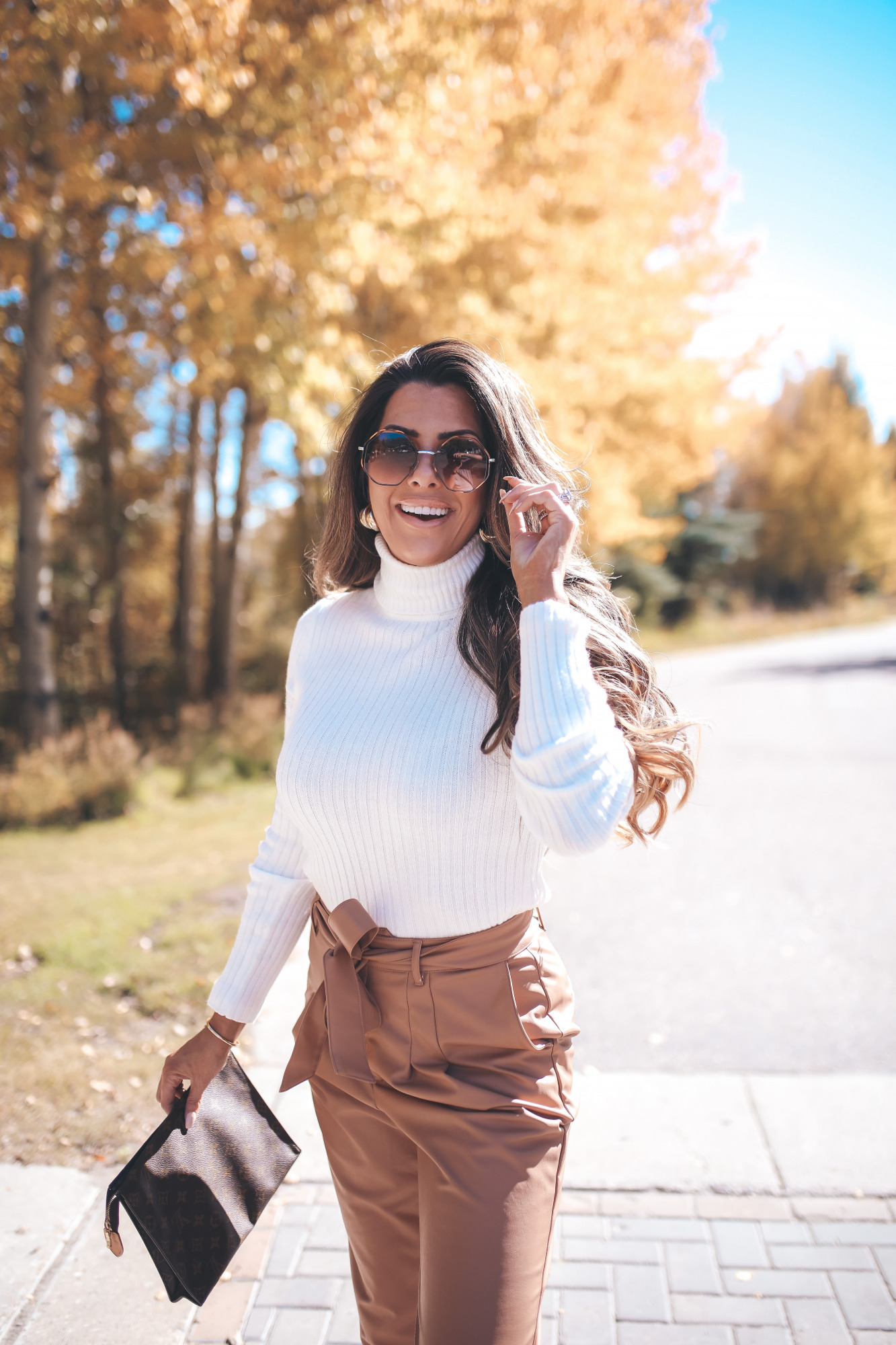 fall fashion outifit ideas pinterest 2020, fall fashion express 2020, fall outfits white booties, emily gemma5 |Fall Outfits by popular US fashion blog, The Sweetest Thing: image of Emily Gemma outside in Jackson Hole and wearing a Express Wide Ribbed Turtleneck Sweater, Express Super High Waisted Vegan Leather Belted Ankle Pant, Express Snakeskin Textured Block Heel Booties, Express Small Twisted Hoop Earrings, and Express Octagon Cut-Out Sunglasses.