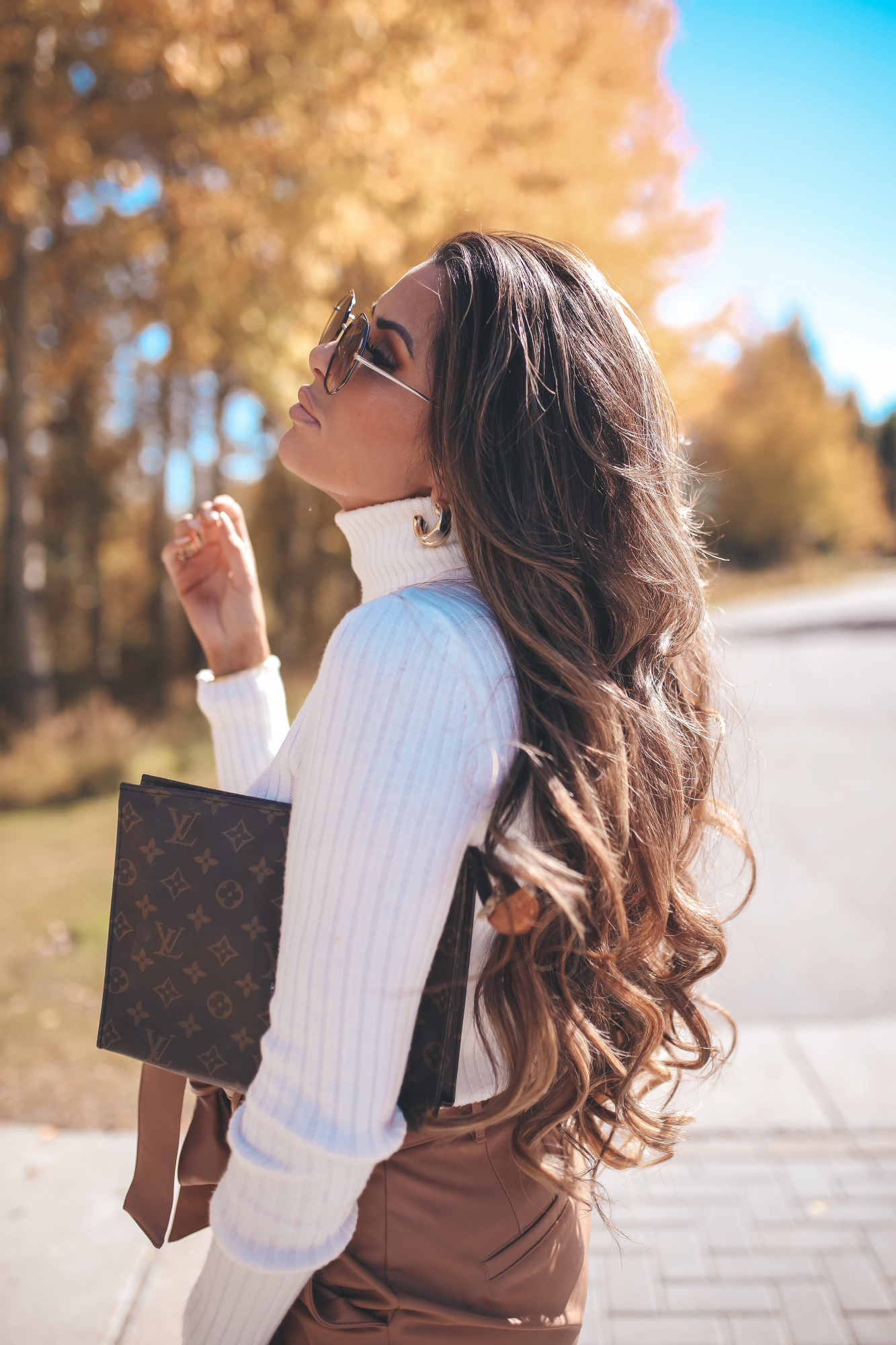 fall fashion outifit ideas pinterest 2020, fall hair color ideas brunette balyage, emily gemma |Fall Outfits by popular US fashion blog, The Sweetest Thing: image of Emily Gemma outside in Jackson Hole and wearing a Express Wide Ribbed Turtleneck Sweater, Express Super High Waisted Vegan Leather Belted Ankle Pant, Express Snakeskin Textured Block Heel Booties, Express Small Twisted Hoop Earrings, and Express Octagon Cut-Out Sunglasses.