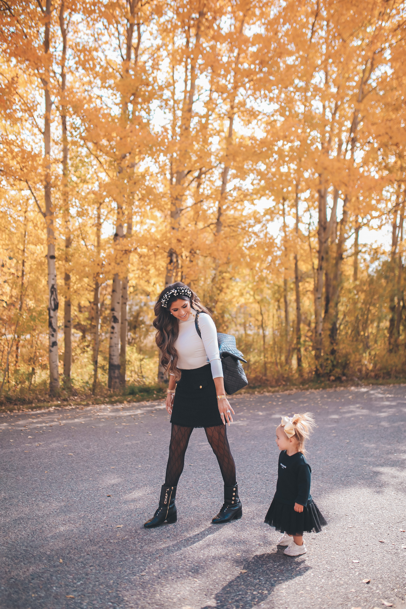 fall fashion pinterest outfits 2020, chanel combat boots black, tweed skirt with gucci tights, emily gemma, JPG |fall fashion pinterest outfits 2020, express fall fashion, emily gemma, baby girl fall outfits | Fall Clothing by popular US fashion blog, The Sweetest Thing: image of Emily Gemma walking outside with her young daughter and wearing a Express Novelty Button Mock Neck Top, Express High Waisted A-Line Tweed Mini Skirt, Chanel boots, Gucci tights, Cartier bracelet and pearl knot headband. 
