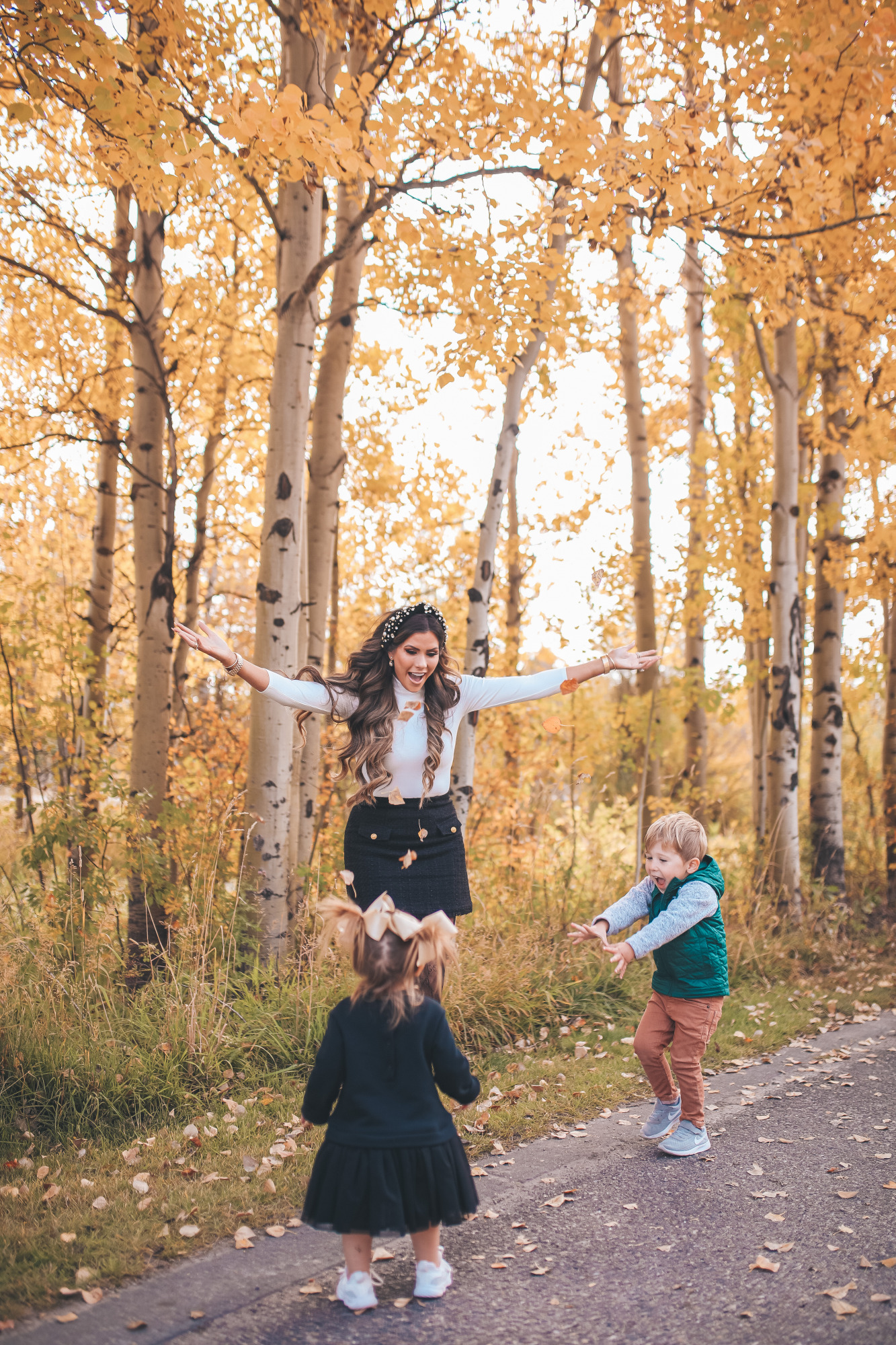 fall fashion pinterest outfits 2020, chanel combat boots black, tweed skirt with gucci tights, emily gemma1|Fall Clothing by popular US fashion blog, The Sweetest Thing: image of Emily Gemma walking outside with her two young kids and wearing a Express Novelty Button Mock Neck Top, Express High Waisted A-Line Tweed Mini Skirt, Chanel boots, Gucci tights, Cartier bracelet and pearl knot headband. 