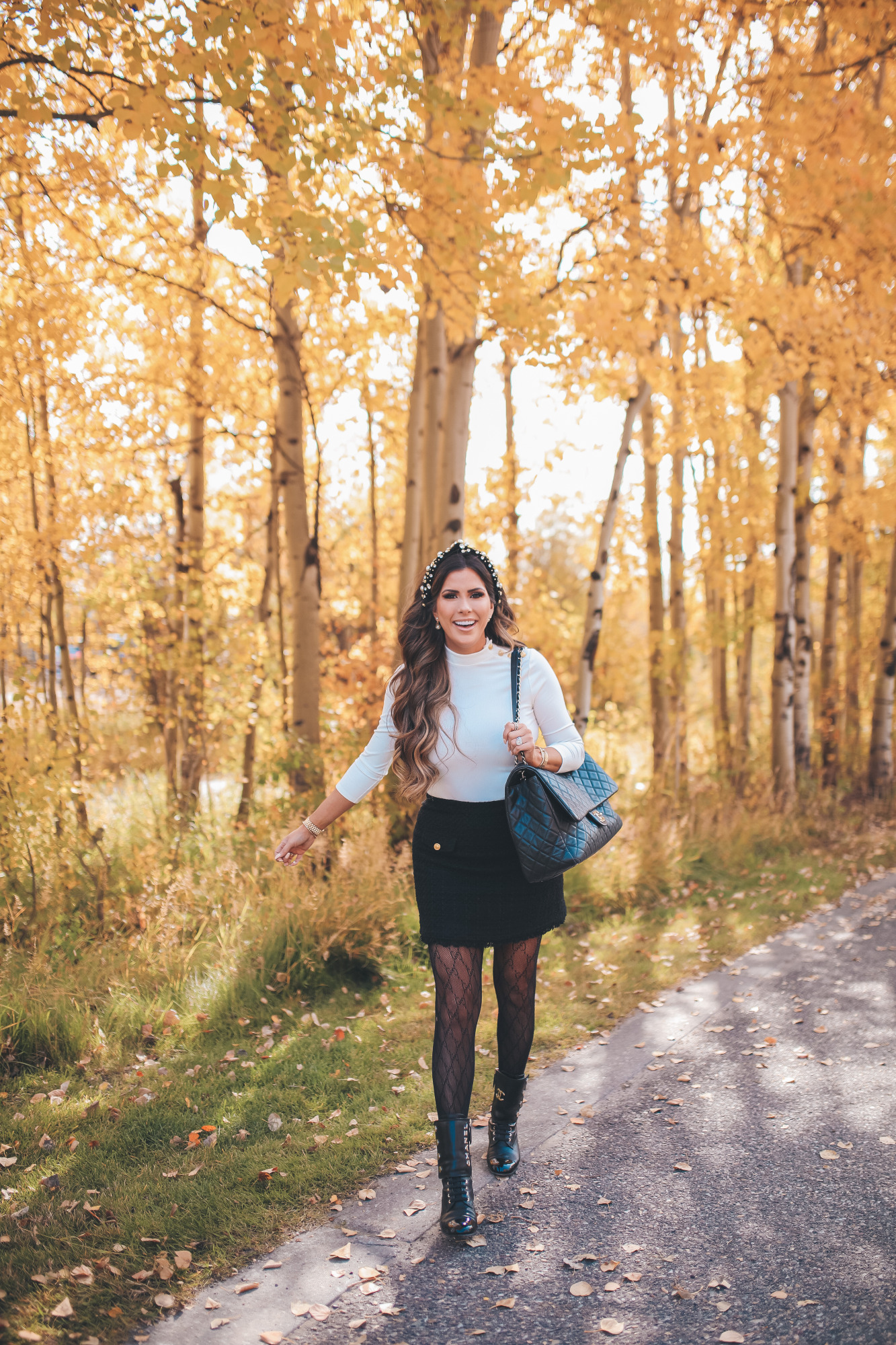 fall fashion pinterest outfits 2020, chanel combat boots black, tweed skirt with gucci tights, emily gemma5 |Fall Clothing by popular US fashion blog, The Sweetest Thing: image of Emily Gemma walking outside and wearing a Express Novelty Button Mock Neck Top, Express High Waisted A-Line Tweed Mini Skirt, Chanel boots, Gucci tights, Cartier bracelet and pearl knot headband. 