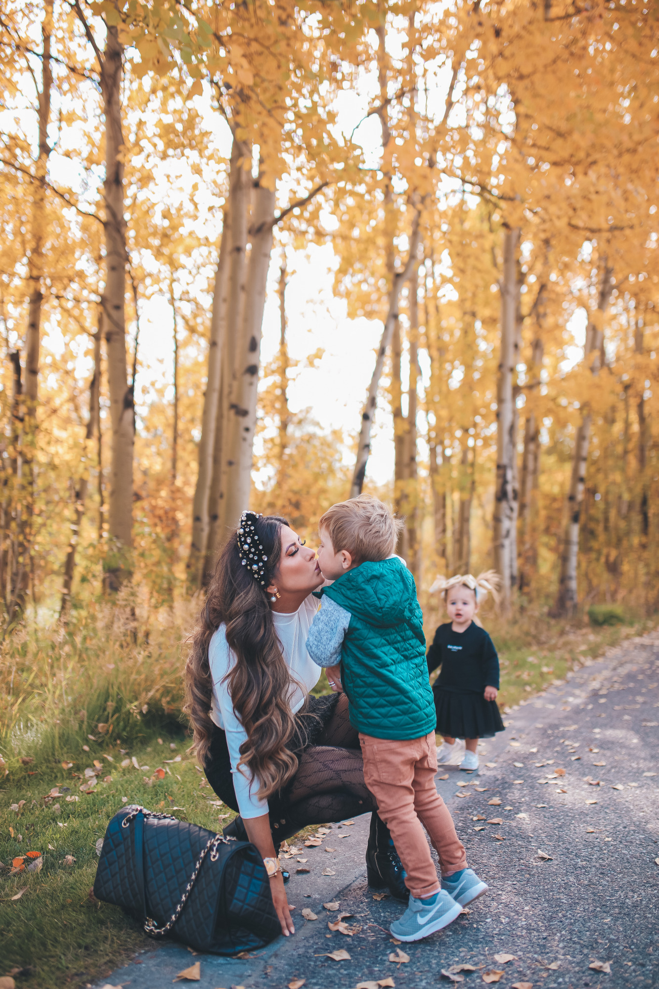 fall fashion pinterest outfits 2020, chanel combat boots black, tweed skirt with gucci tights, emily gemma7 |November Instagram Recap by popular US lifestyle blog, The Sweetest Thing: image of Emily Gemma kissing her young son on the lips and wearing a white Express turtleneck, Gucci tights, Chanel ankle boots, Express black mini skirt, pearl embellished knot headband, and gold Rolex watch. 