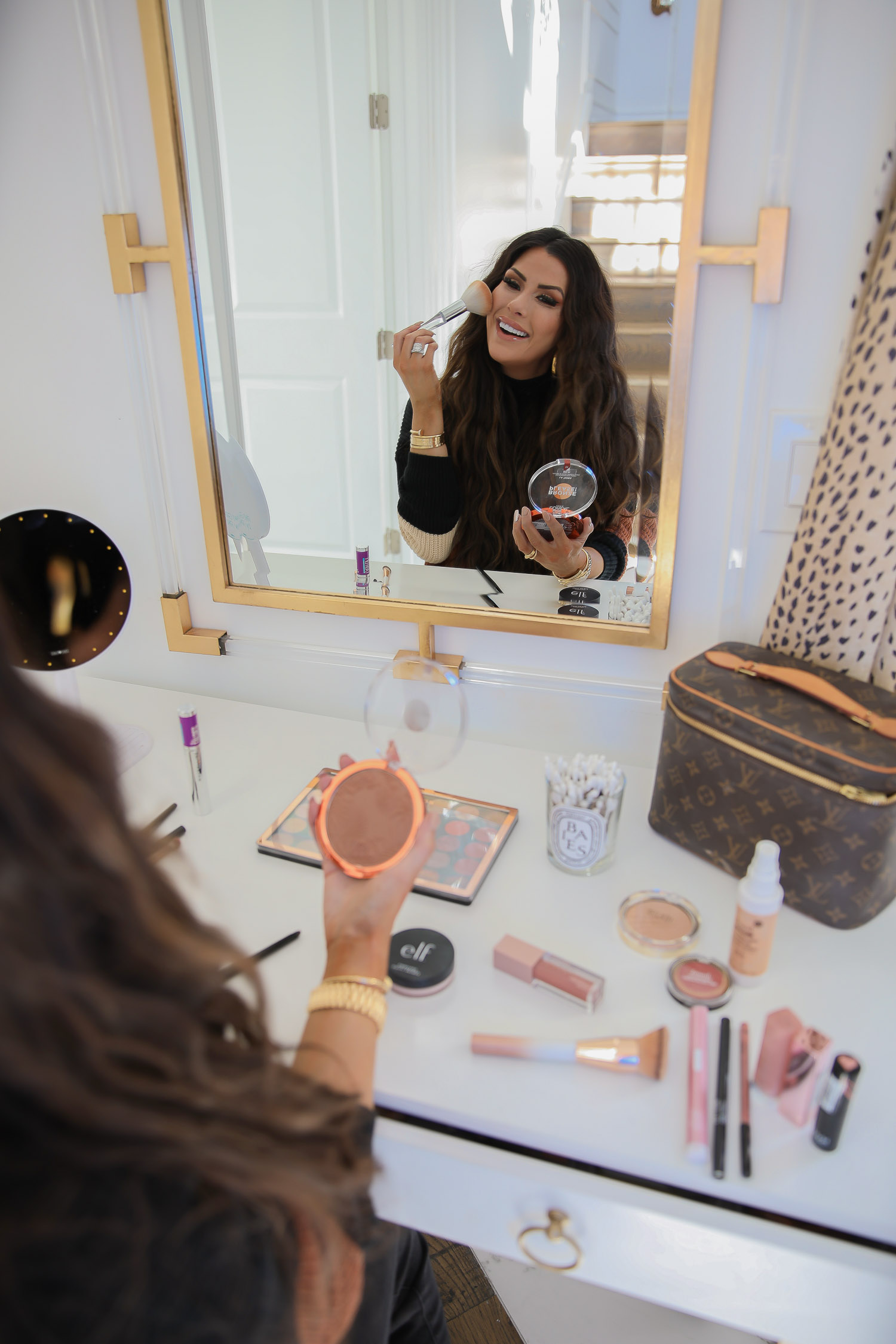 walmart beauty blog post, best drugstore makeup fall 2020, leopard print qtips, Mirage revolution palette review, best drugstore makeup brushes |November Instagram Recap by popular US lifestyle blog, The Sweetest Thing: image of Emily Gemma wearing a Red Dress black and tan stripe sweater and looking at herself in her vanity mirror while applying bronzer. 