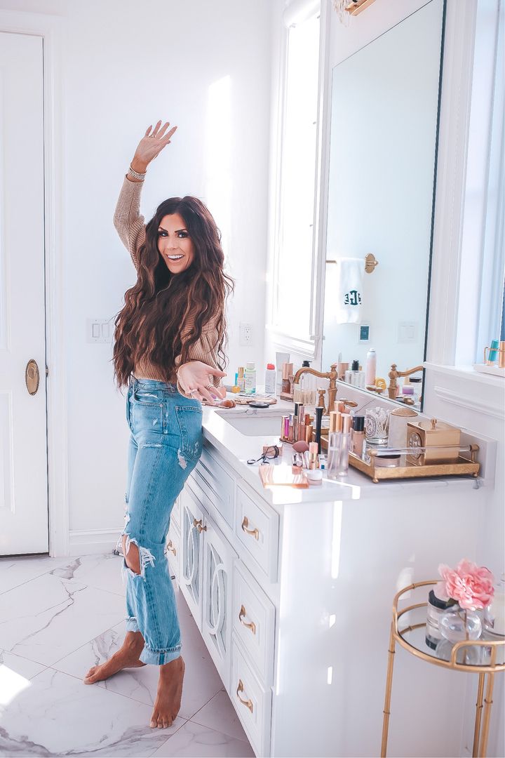 November Instagram Recap by popular US lifestyle blog, The Sweetest Thing: image of Emily Gemma leaning up against her bathroom vanity and wearing a tan Express long sleeve top and pair of Agolde jeans. 