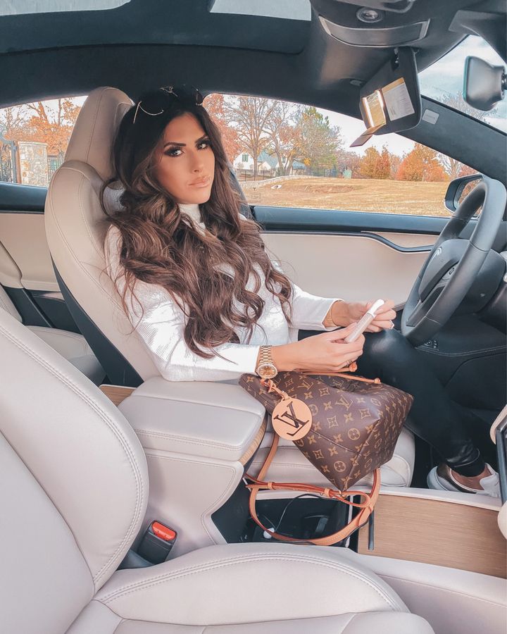November Instagram Recap by popular US lifestyle blog, The Sweetest Thing: image of Emily Gemma sitting in her car and wearing a Amazon long sleeve white shimmer top, black faux leather leggings, and sitting next to her Louis Vuitton bag. 