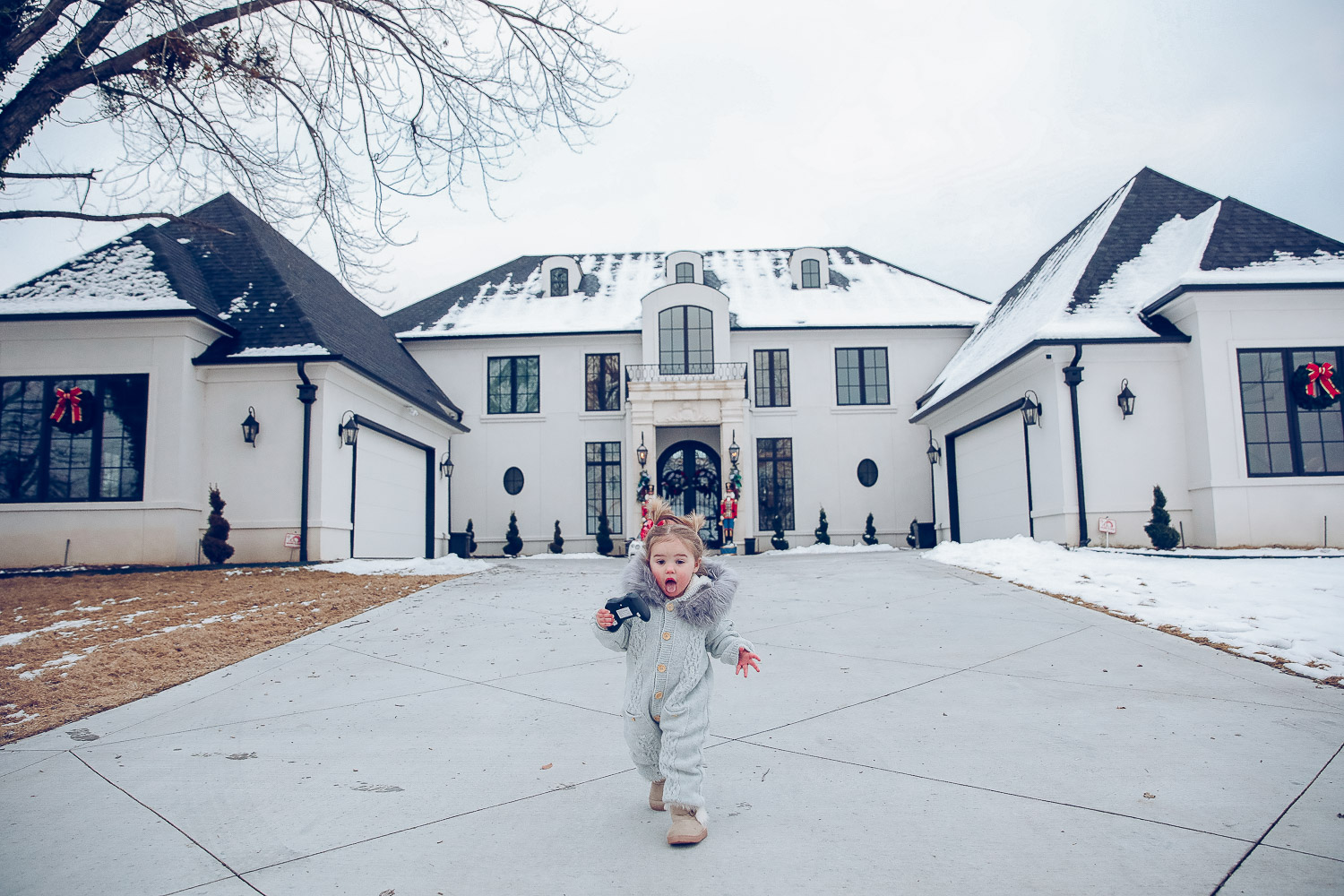 Christmas outdoor decorations home depot, emily gemma home, christmas wreaths on gates with bow, blow up nutcrackers, |Holiday Home Decor by popular US life and style blog, The Sweetest Thing: image of the front of a house decorated with nutcrackers and Christmas wreaths. 