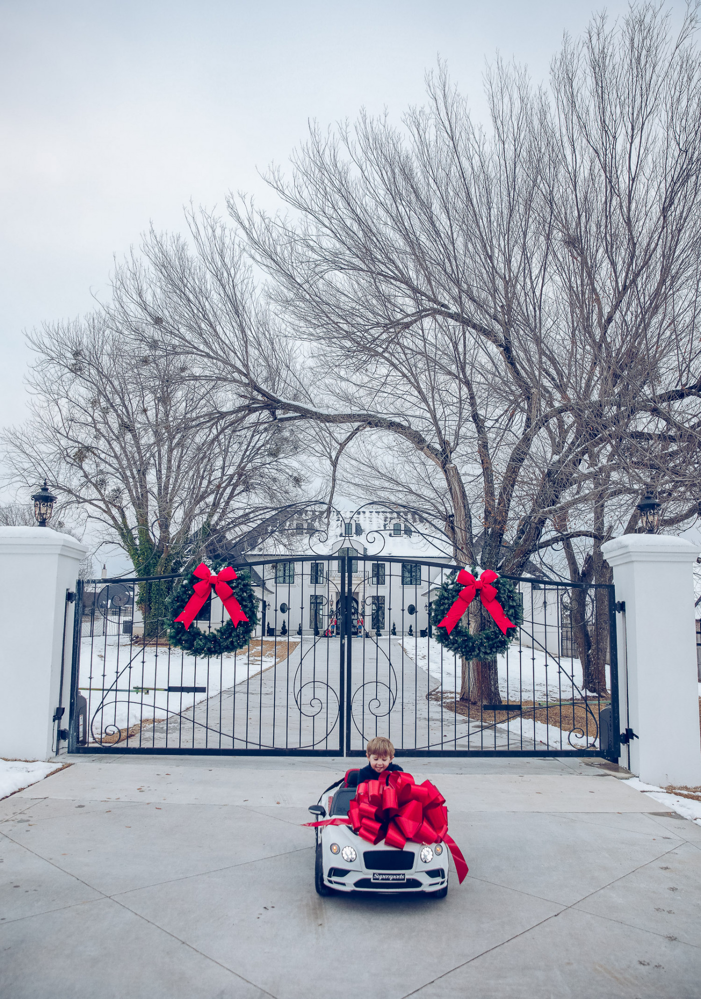 Christmas outdoor decorations home depot, emily gemma home, christmas wreaths on gates with bow, blow up nutcrackers, |Holiday Home Decor by popular US life and style blog, The Sweetest Thing: image of the front of a house decorated with nutcrackers and Christmas wreaths. 