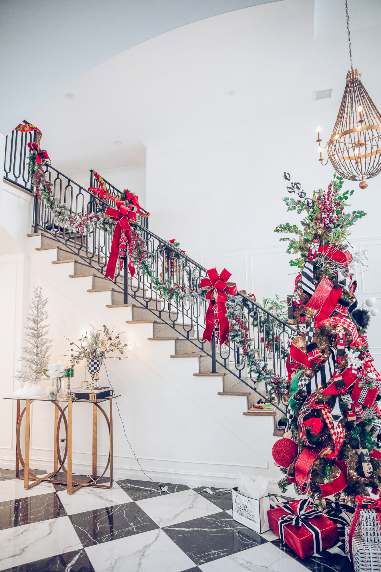 Christmas outdoor decorations home depot, emily gemma home, christmas wreaths on gates with bow, blow up nutcrackers, |Holiday Home Decor by popular US life and style blog, The Sweetest Thing: image of a entry way decorated with wreaths, holiday bows, faux garland, and a nutcracker Christmas tree. 