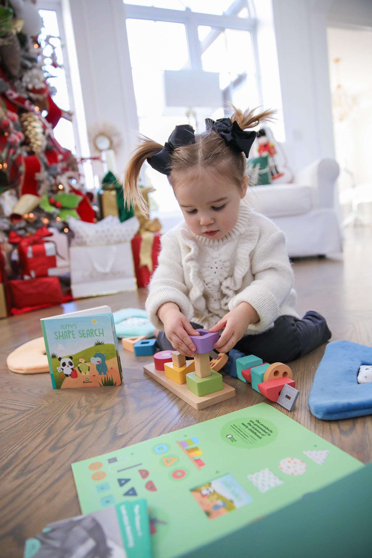 Educational Gift Ideas for Kids by popular US lifestyle blog, The Sweetest Thing: image of a girl playing with KiwiCo toys. 