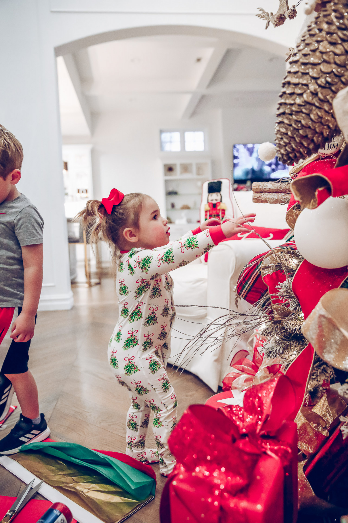walmart gift wrap christmas 2020, shop hello holidays christmas tree, magnetic me PJs, emily ann gemma-10 |Gift Wrapping Ideas by popular US life and style blog, The Sweetest Thing: image of a little girl wearing Magnetic Me Christmas pjs while standing in front of her Christmas tree. 