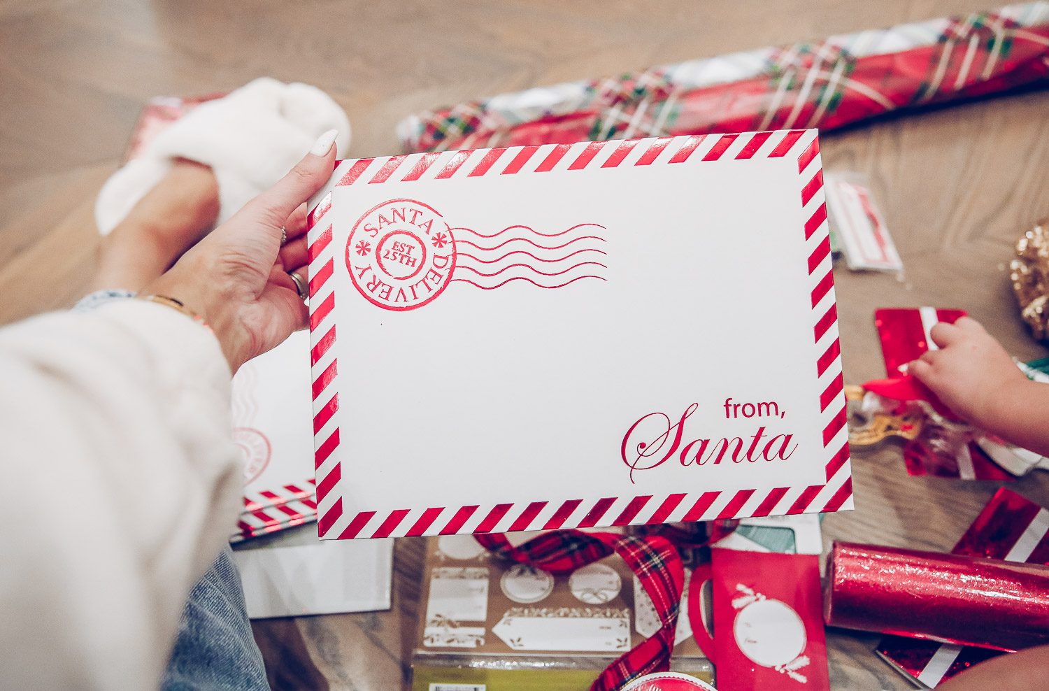 walmart gift wrap christmas 2020, shop hello holidays christmas tree, magnetic me PJs, emily ann gemma-10 |Gift Wrapping Ideas by popular US life and style blog, The Sweetest Thing: image of a woman holding a From Santa cardboard envelope. 