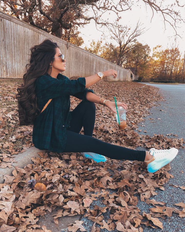 November Instagram Recap by popular US lifestyle blog, The Sweetest Thing: image of Emily Gemma sitting on a street curb and wearing a Superdown blue and green plaid shirt, black Zella leggings, Alexander McQueen sneakers, and Louis Vuitton backpack. 
