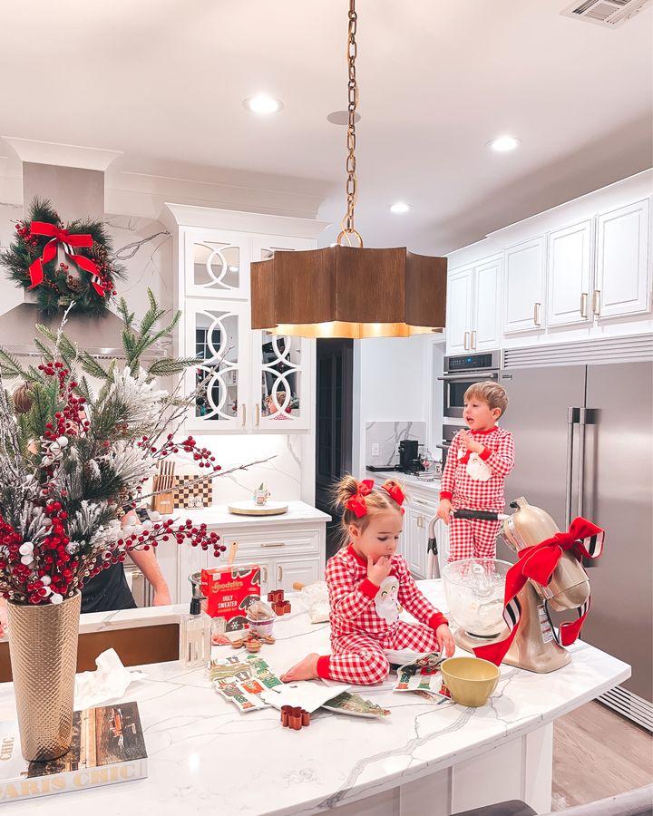 November Instagram Recap by popular US lifestyle blog, The Sweetest Thing: image of Emily Gemma's son and daughter wearing red and white plaid Santa pajamas and making cookies in their kitchen. 