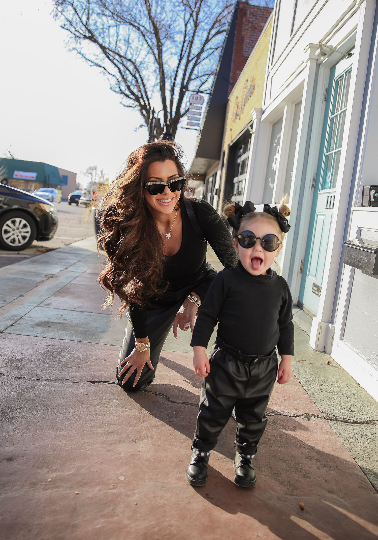 matching mommy daughter fashion outfits Pinterest, Emily Gemma, Nordstrom BP faux leather pants, loewe sunglasses, Alexander mcqueen sneakers gold white outfit pinterest |Mommy and Daughter by popular US fashion blog, The Sweetest Thing: image of a woman and her daughter walking together outside and wearing a pair of BP faux leather pants, Good American top, loewe sunglasses, Alexander mcqueen sneakers, Monica Vinader ring, Nadri bracelet, Nadri earrings, and Rolex watch.