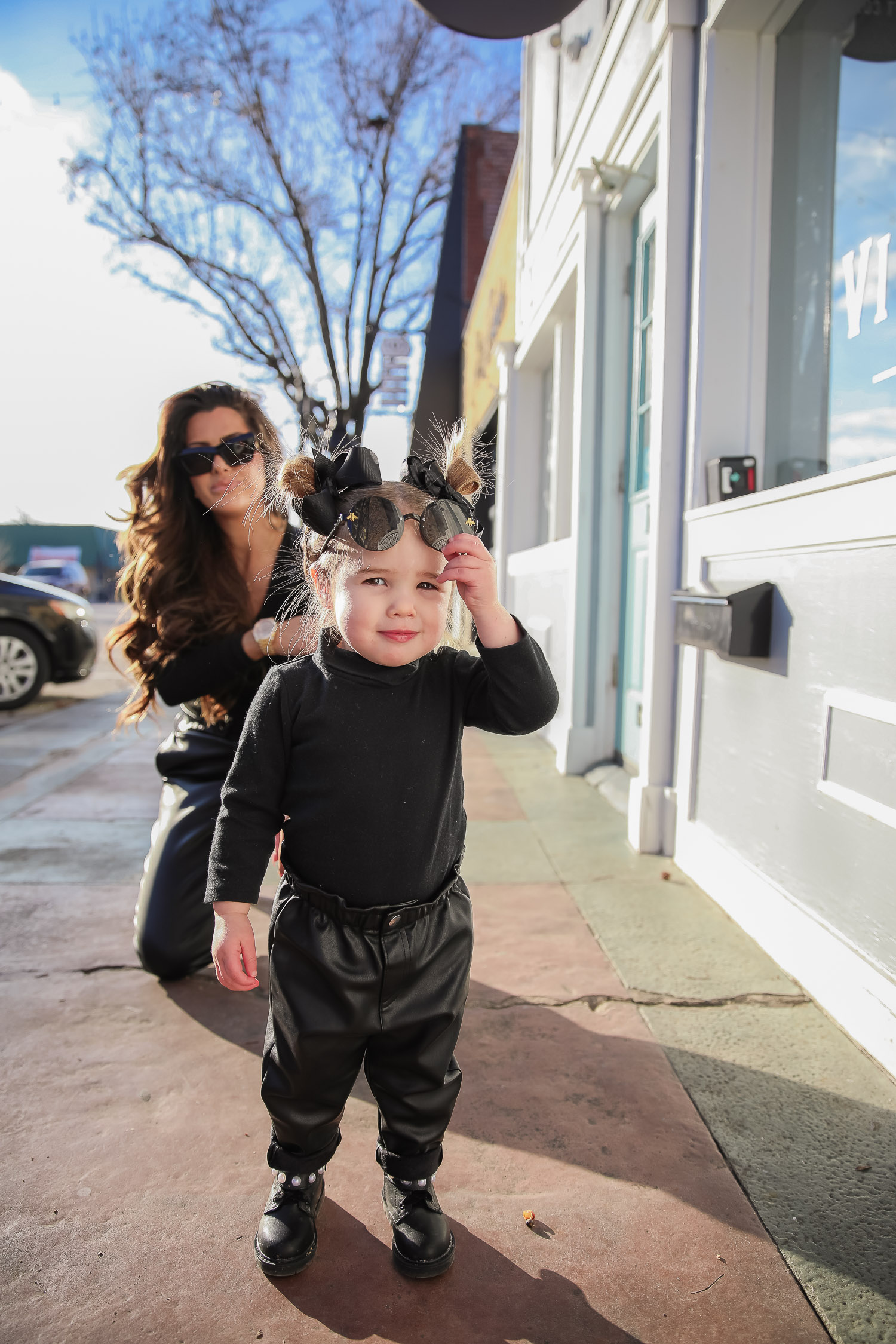 matching mommy daughter fashion outfits Pinterest, Emily Gemma, Nordstrom BP faux leather pants, loewe sunglasses, Alexander mcqueen sneakers gold white outfit pinterest |Mommy and Daughter by popular US fashion blog, The Sweetest Thing: image of a woman and her daughter walking together outside and wearing a pair of BP faux leather pants, Good American top, loewe sunglasses, Alexander mcqueen sneakers, Monica Vinader ring, Nadri bracelet, Nadri earrings, and Rolex watch.