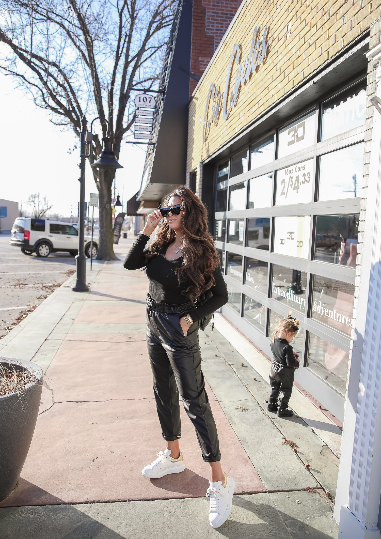 matching mommy daughter fashion outfits Pinterest, Emily Gemma, Nordstrom BP faux leather pants, loewe sunglasses, Alexander mcqueen sneakers gold white outfit pinterest |Mommy and Daughter by popular US fashion blog, The Sweetest Thing: image of a woman and her daughter walking together outside and wearing a pair of BP faux leather pants, Good American top, loewe sunglasses, Alexander mcqueen sneakers, Monica Vinader ring, Nadri bracelet, Nadri earrings, and Rolex watch.