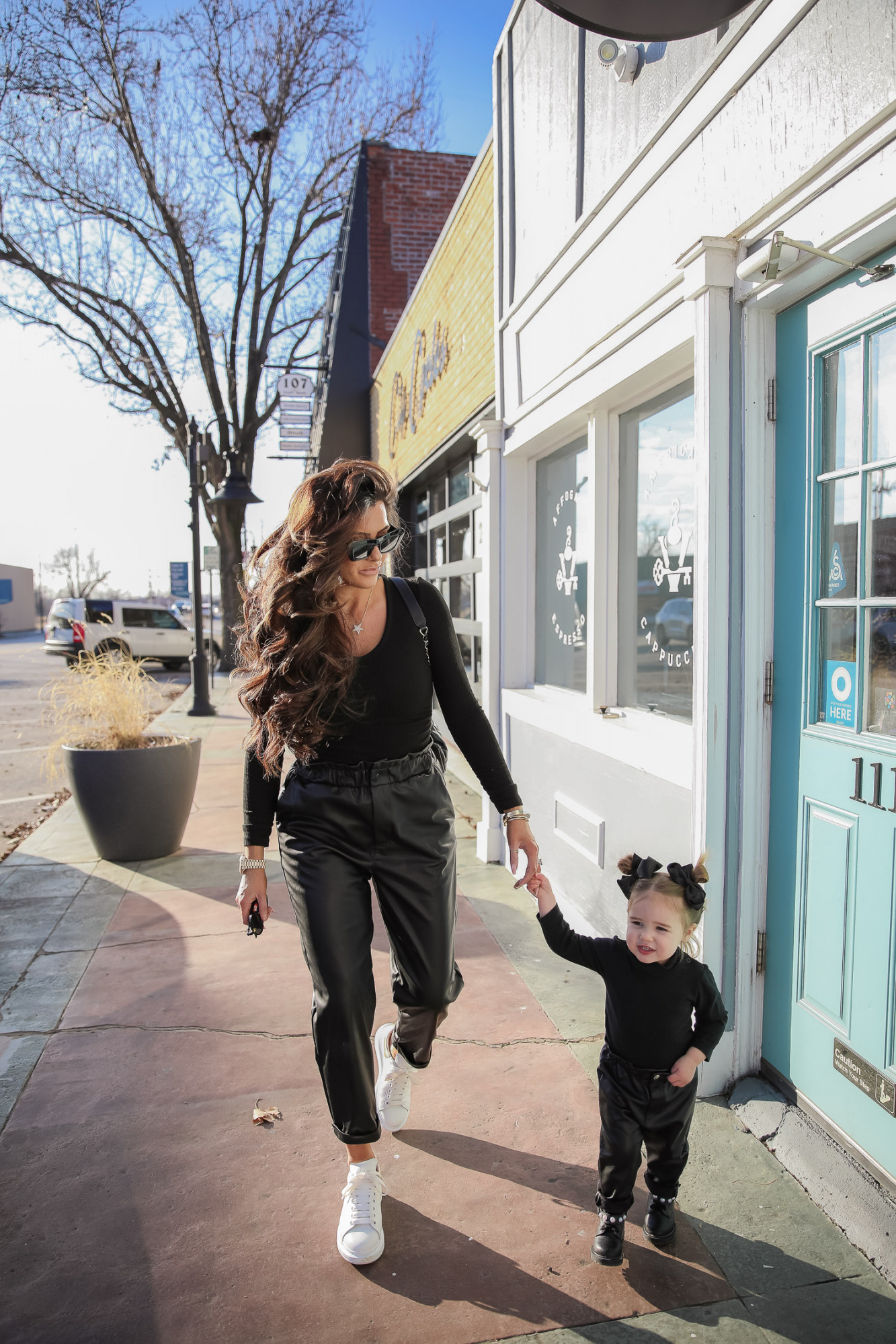 matching mommy daughter fashion outfits Pinterest, Emily Gemma, Nordstrom BP faux leather pants, loewe sunglasses, Alexander mcqueen sneakers gold white outfit pinterest | Mommy and Daughter by popular US fashion blog, The Sweetest Thing: image of a woman and her daughter walking together outside and wearing a pair of BP faux leather pants, Good American top, loewe sunglasses, Alexander mcqueen sneakers, Monica Vinader ring, Nadri bracelet, Nadri earrings, and Rolex watch.