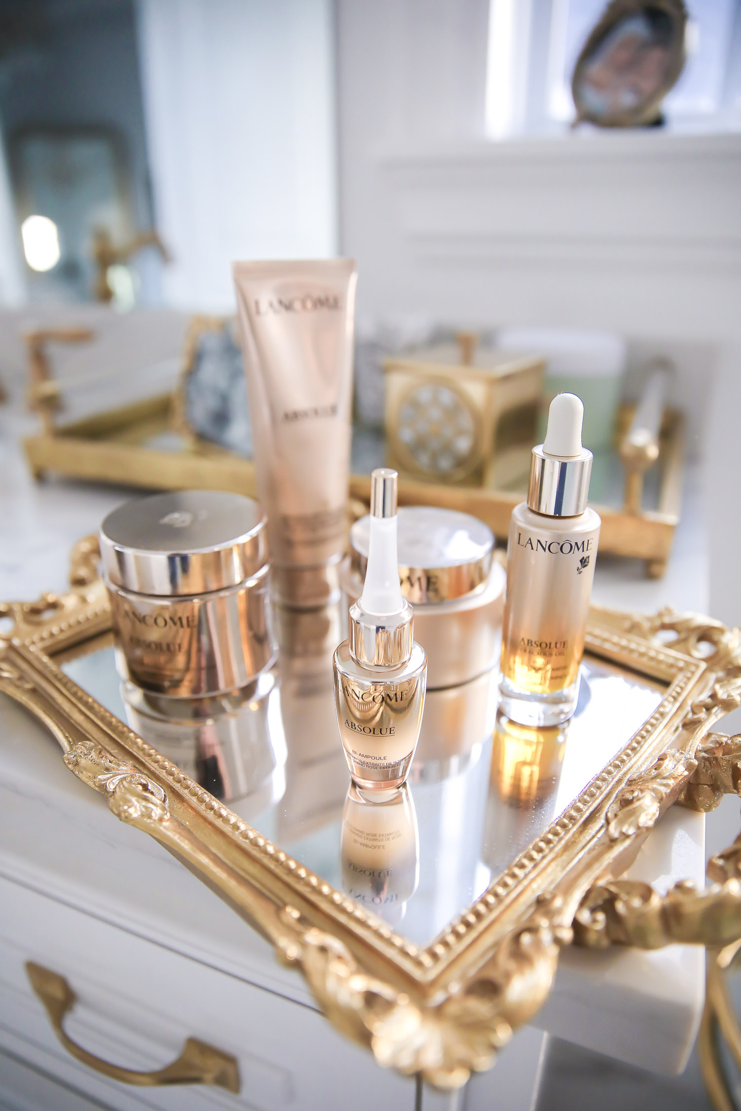 Lancome Skincare by popular US beauty blog, The Sweetest Thing: image of Lancome Absolue skincare products on a mirrored tray with gold handles. 