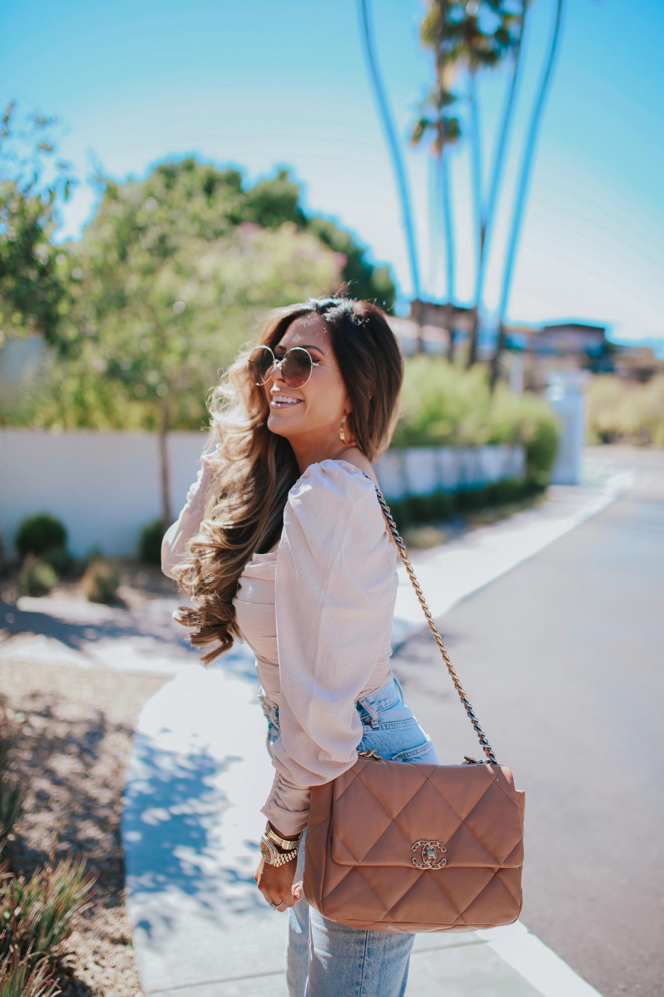 Chanel 19 flap tan brown medium, The Scott Scottsdale hotel, emily gemma, Mom jeans outfit 2021 pinterest11 |Mom Jeans by popular US fashion blog, The Sweetest Thing: image of Emily Gemma at standing outside in Scottsdale, Arizona and wearing Slvrlake mom jeans, Astr the Label top, gold Rolex watch, Cartier rings, Chanel purse, cartier bracelets, and Chanel necklace. 