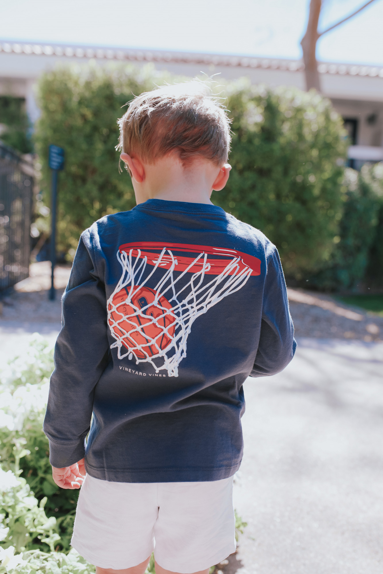 emily gemma, nordstrom vineyard vines tee shirt kids, scottsdale fashion blogger |Mom Jeans by popular US fashion blog, The Sweetest Thing: image of a little boy standing outside in Scottsdale, Arizona and wearing a Vineyard Vines t-shirt with tan shorts.