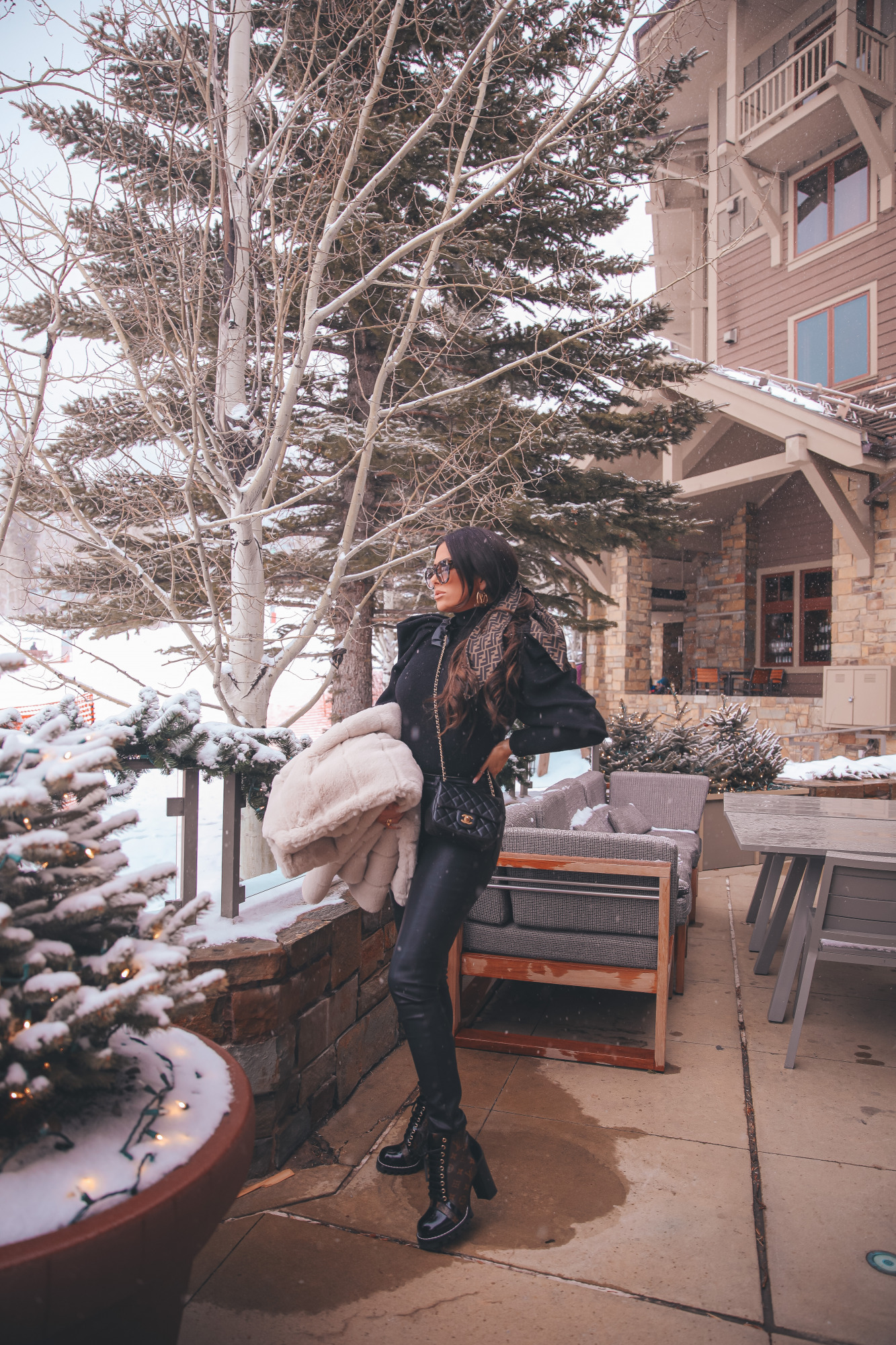 fendi hair scarf scrunchie, Louis Vuitton Star Trail Ankle Boot, Louise Hoop Earrings, Fendi Roma Sunglasses, Emily Gemma, the sweetest thing blog |Jackson Hole Winter by popular US fashion blog, The Sweetest Thing: image of Emily Gemma wearing a BB Dakota tan faux fur coat, black Express ruffle shoulder top, Fendi sunglasses, Black BlankNYC faux leather leggings, Louis Vuitton boots, Fendi hair scarf, Louis Vuitton earrings, and a Chanel black quilted purse. 