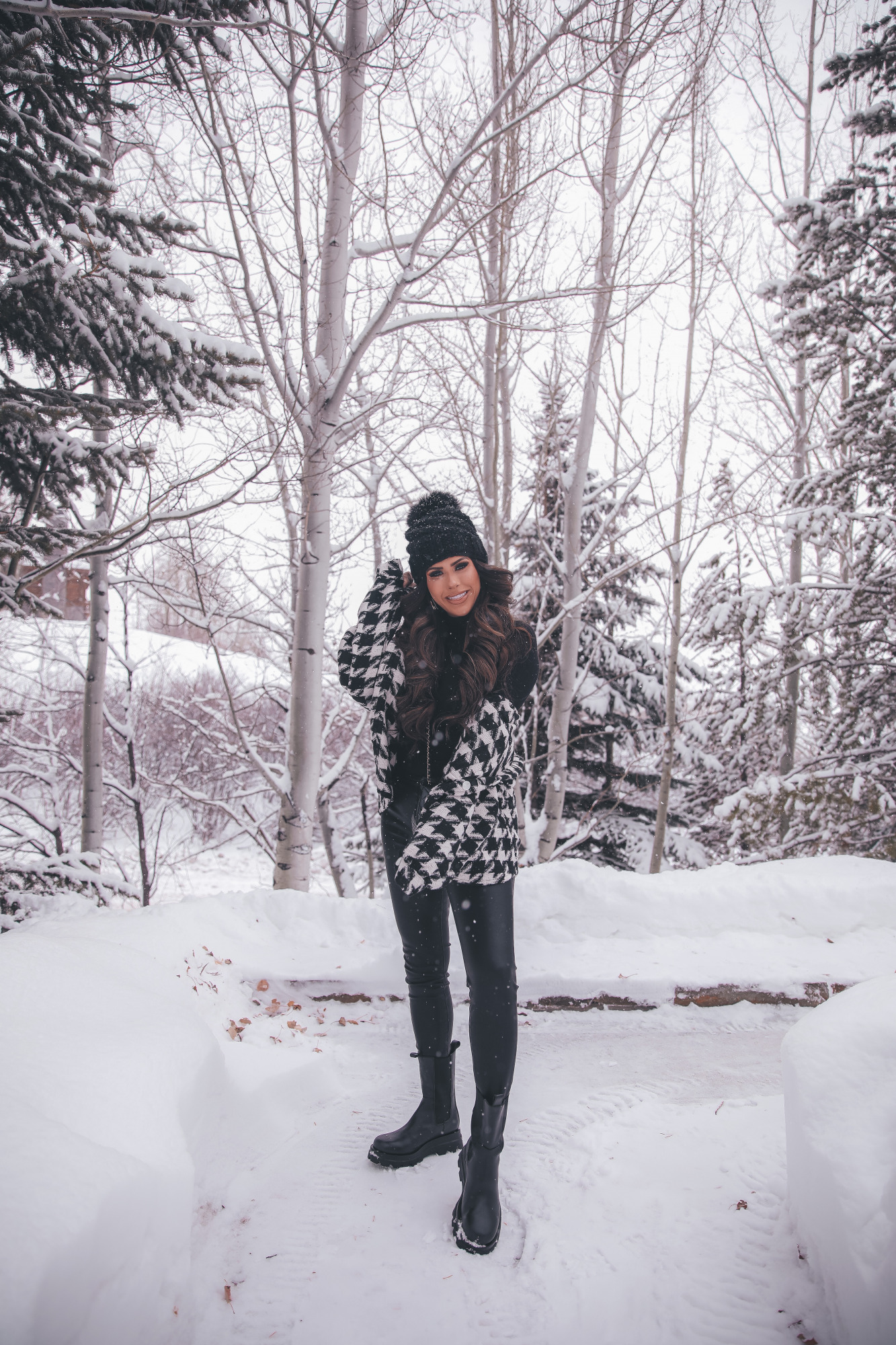 houndstooth shacket storets, lug sole black boot outfit ideas pinterest, jackson hole, winter fashion outfits |Lug Sole Boots by popular US fashion blog, The Sweetest Thing: image of Emily Gemma wearing a Storets black and white houndstooth jacket, Good American bodysuit, BlankNYC faux leather pants, Steve Madden black lug sole boots, BP. sunglasses, TopShop black pom beanie, Chanel handbag, Monica Vinader ring, Rolex watch, Cartier bracelets, and Iconic Nude' + KIM K.W. + White Russian Sparkle lip combo. 