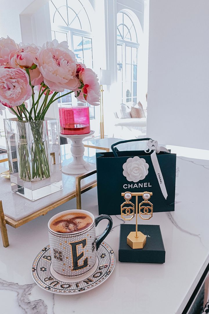 Kitchen Decor, Peonies, Glass Vase, Chanel Earrings, Emily Gemma, Latte Art, Gold Marble Tray, Emily Gemma Home |Instagram Recap by popular US fashion blog, The Sweetest Thing: image of a Chanel shopping bag, Chanel earrings on a gold earring stand, Monogram Anthropologie mug, and clear glass vase filled with pink peonies. 