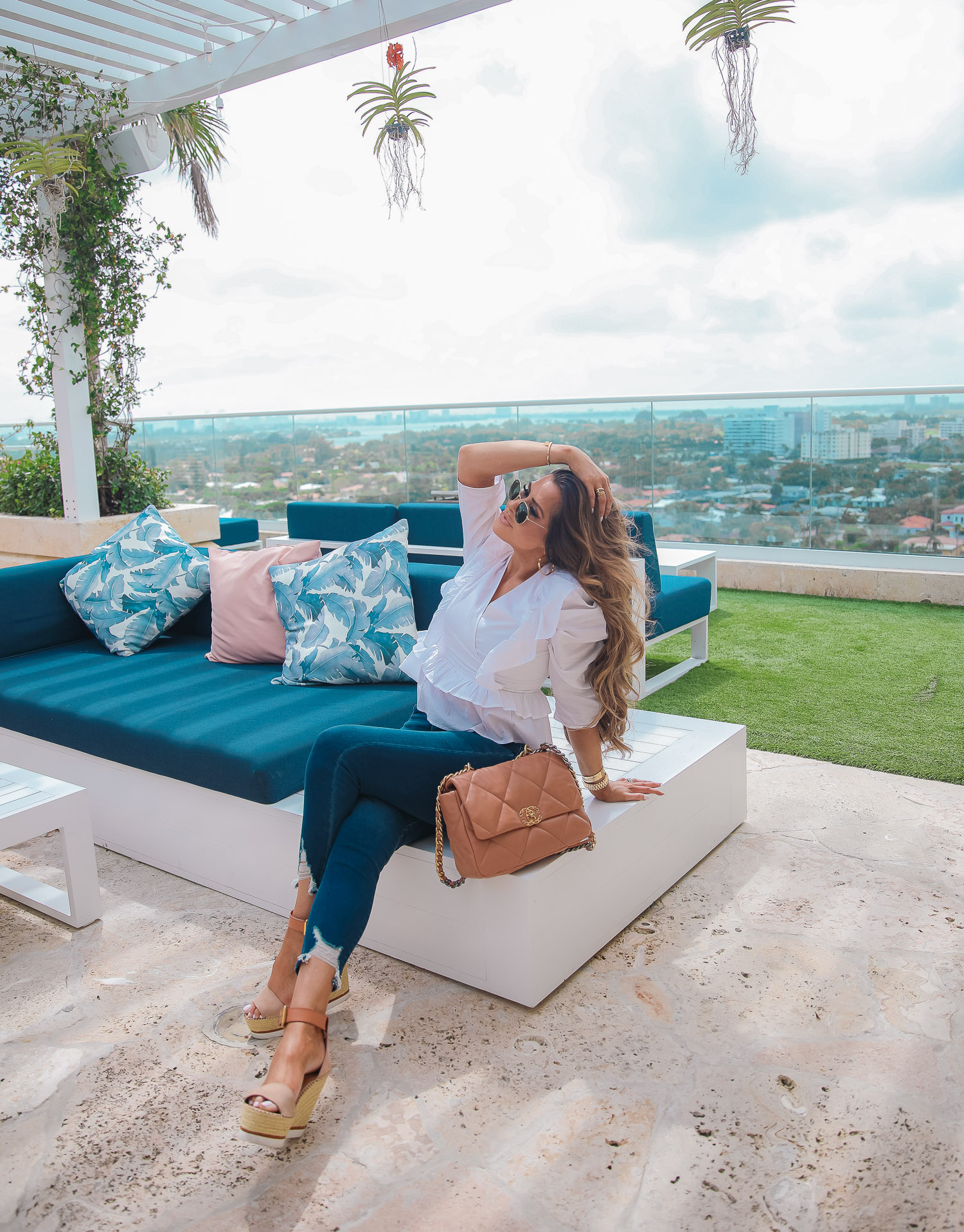 EXPRESS spring fashion, good american jean dupes, chanel 19 medium tan carmel color, emily gemma, the grand miami surfside |Spring Fashion by popular US fashion blog, The Sweetest Thing: image of Emily Gemma wearing a Express white white ruffle and puff sleeve top, Express Jeans, Espadrille sandals, and holding a Chanel 19 bag. 