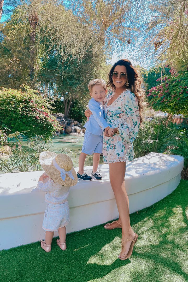 VICI Fashion by popular US fashion blog, The Sweetest Thing: image of Emily Gemma wearing a VICI floral print romper and tan strap sandals while standing outside with her two young kids. 