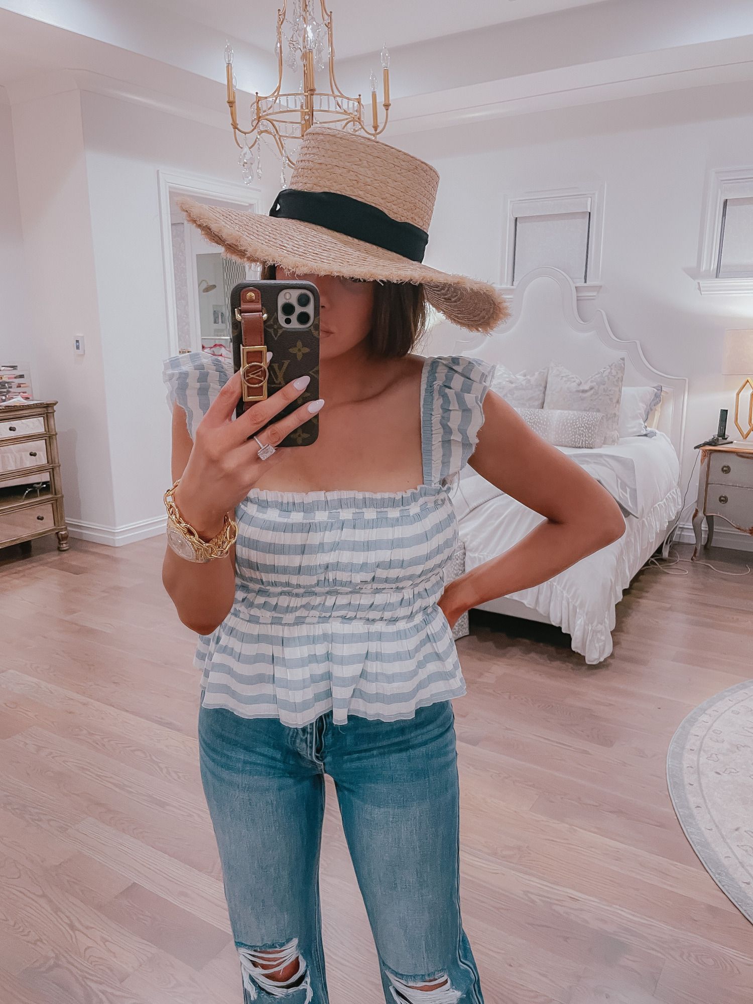 Vici Try On by popular US fashion blog, The Sweetest Thing: image of Emily Gemma wearing a Vici blue and white stripe peplum top, straw hat, and deconstructed jeans. 