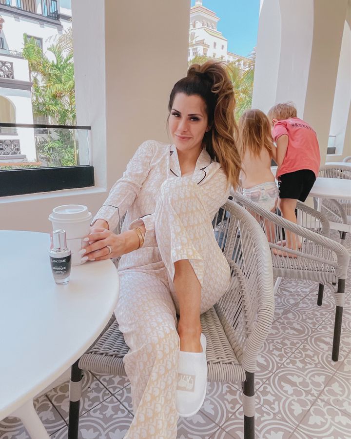 Designer Dupe Pajamas, Emily Gemma, White Elephant Palm Beach, Lancome Genefique Review, Gemma Gang | April Instagram Recap by popular US fashion blog, The Sweetest Thing: image of Emily Gemma sitting out on a patio with her two young kids and wearing white slippers and cream and white print pajamas. 