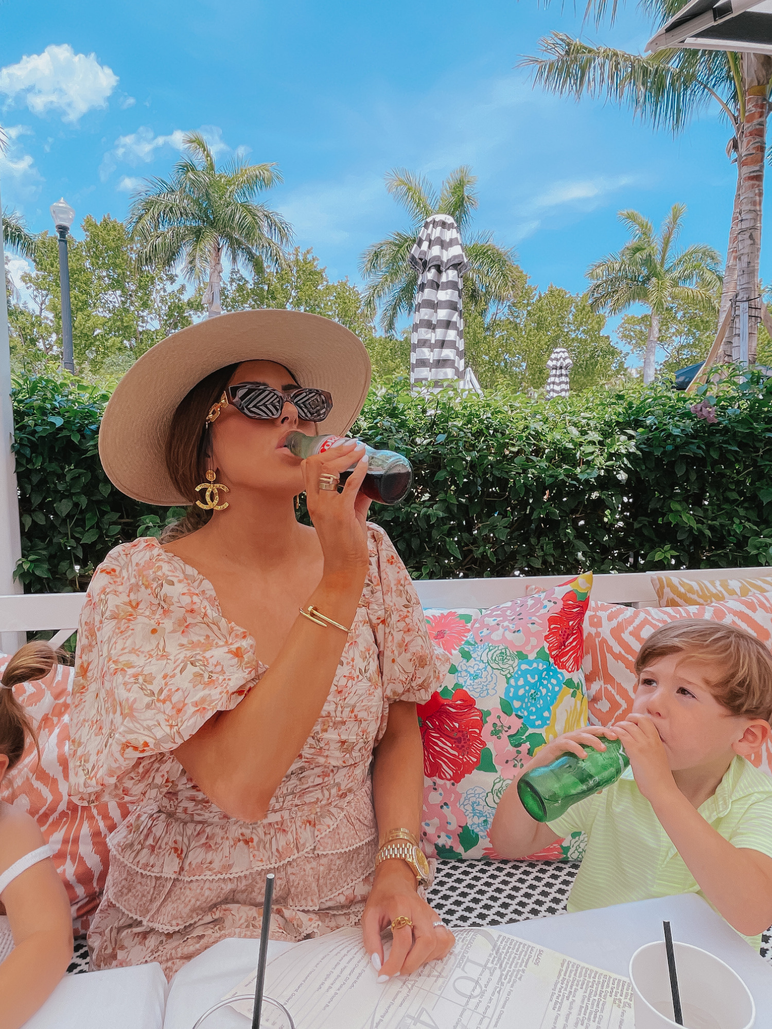 Palm beach white elephant lola41, cute outfit ideas palm beach, where to stay palm beach | Lola 41 by popular US fashion blog, The Sweetest Thing: image of Emily Gemma and her daughter Sophie and son Luke sitting outside and eating food at Lola 41 while wearing Tularosa Shaylee dress, Paris Large Button Chanel Earrings, dior pink toile small book tote, Louis Vuitton Edge Sunglasses, chanel gold button earrings, Rag and Bone hat, Cartier bracelets, Janie and Jack white tank top, and Vineyard Vines polo shirt.  