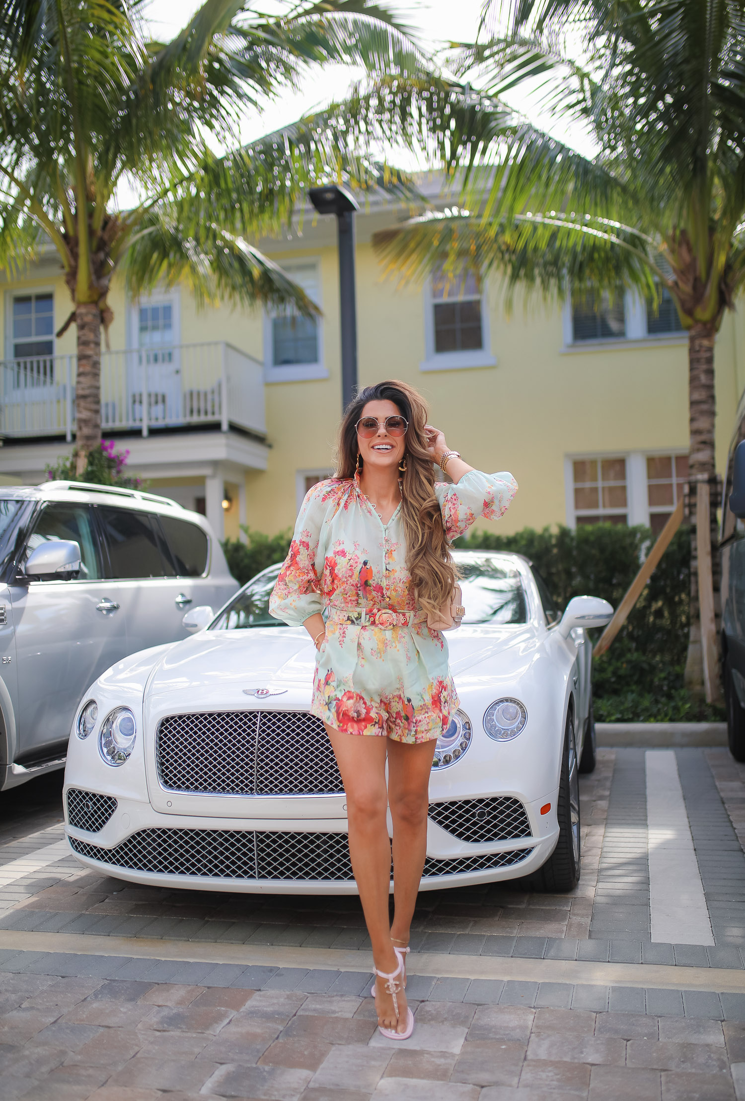 Palm beach where to stay, White elephant palm beach, Zimmerman Mae Floral Shorts and Blouse, Tiktok viral jewelry anklet, Amazon Tiktok Viral anklet, Chanel Large Button Paris Gold earrings, high end fashion blog, Emily gemma, the sweetest thing blog, luxury travel blog, palm beach white elephant | Zimmermann Outfit by popular US fashion blog, The Sweetest Thing: image of Emily Gemma standing by a white Bentley and wearing a Zimmerman Mae Floral Shorts and Blouse, Tiktok viral jewelry anklet, Amazon Tiktok Viral anklet, Chanel Large Button Paris Gold earrings, Cartier bracelets, gold Rolex watch, Chanel sandals and carrying a Chanel handbag.  
