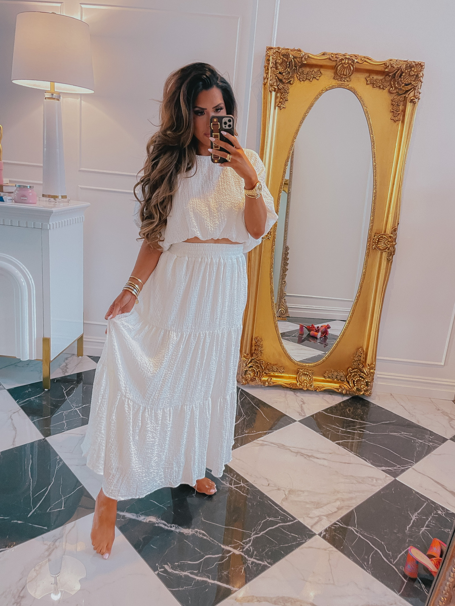 Red Dress Boutique, Try On Haul, Emily Ann Gemma, White Midi Skirt, White Midi Top, White Summer Outfit Ideas, White Top | Instagram Recap by popular US life and style blog, The Sweetest Thing: image of Emily Gemma wearing a white crop top and tiered maxi skirt and holding a smartphone in a Louis Vuitton phone case. 