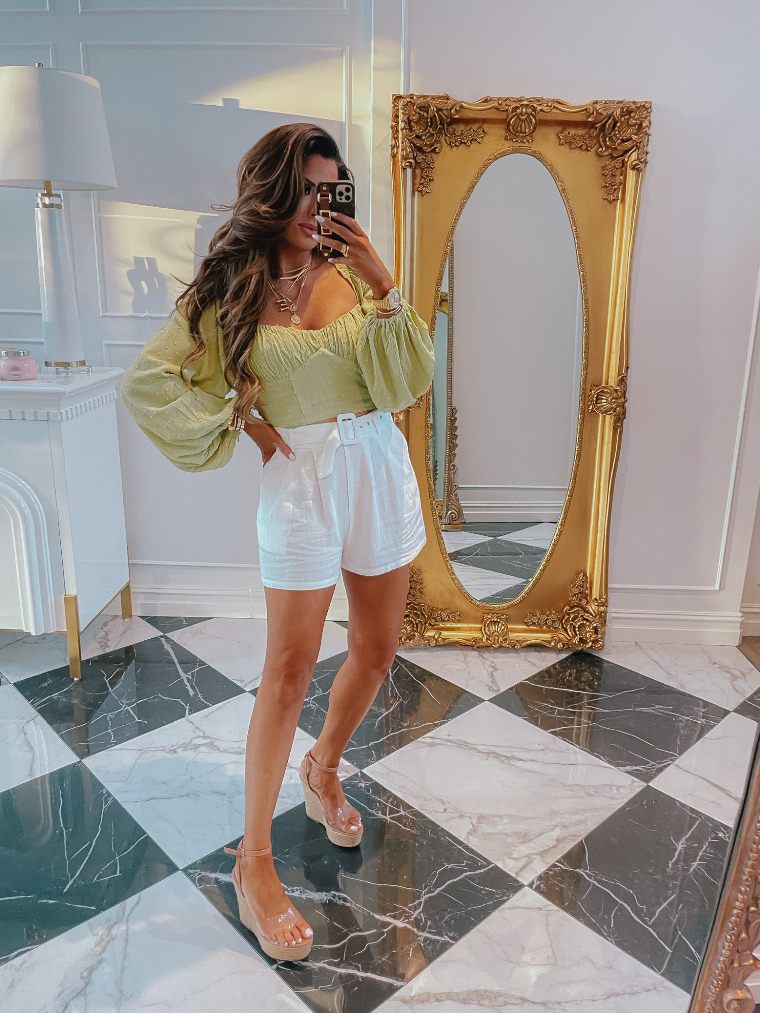 Emily-ann-gemma-forever-21-try-on-haul-ltk-day-sale-shorts-summer-outfit | LTK Sales by popular US fashion blog, The Sweetest Thing: image of Emily Gemma wearing a green puff sleeve blouse, white shorts, and brown espadrilles. 