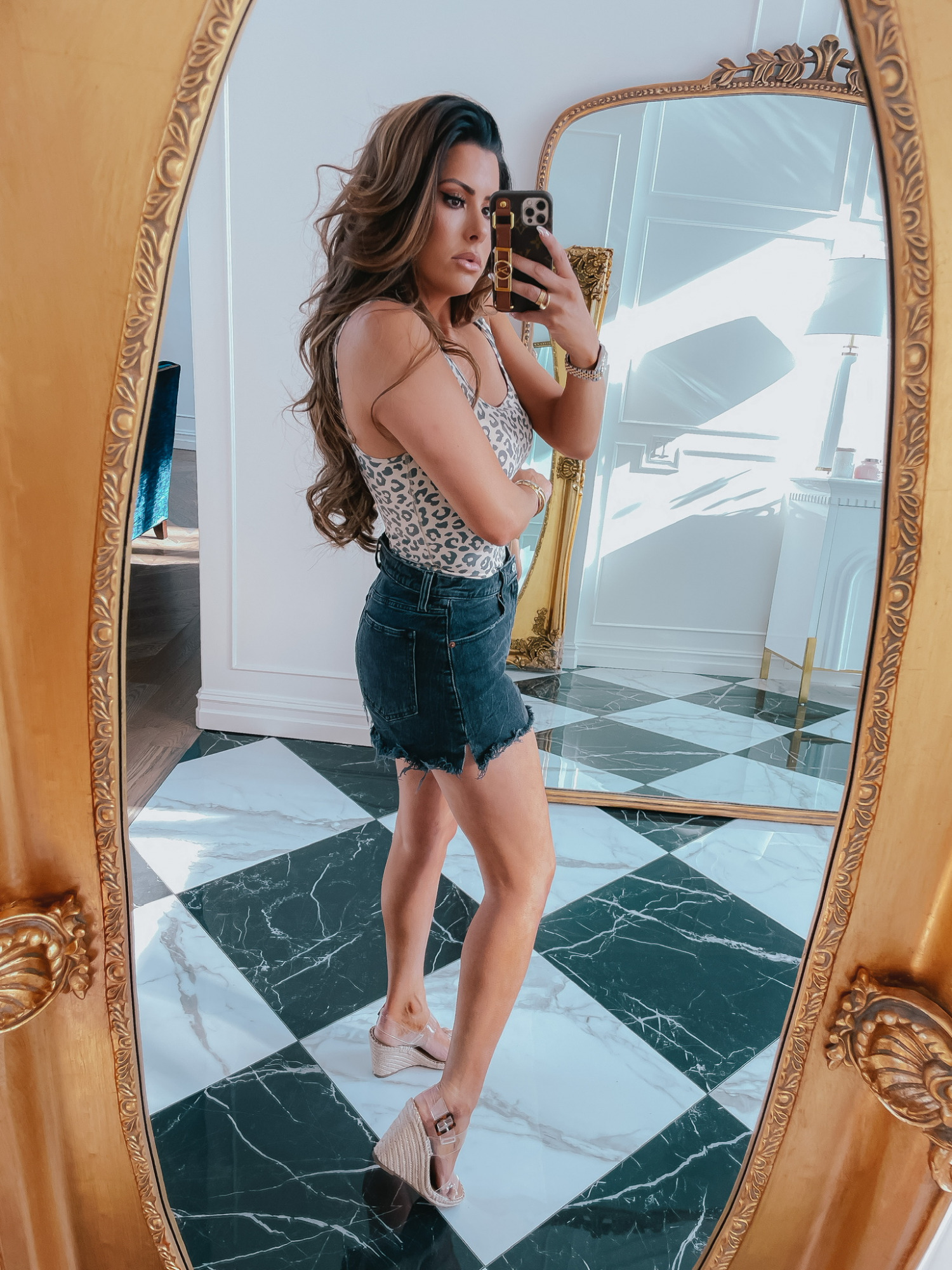 Emily-ann-gemma-abercrombie-sale-jean-shorts-bodysuit-summer-outfit-ltk-day-sale | June Instagram Recap by popular US fashion blog, The Sweetest Thing: image of Emily Gemma wearing a leopard print body suit, black distressed shorts and clear strap wedges. 