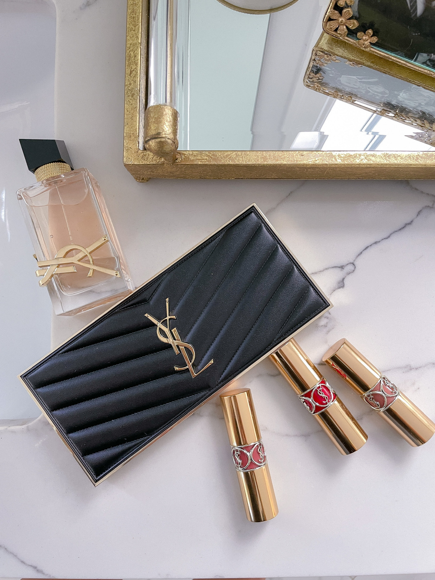 YSL-beaute-review-lipstick-rouge-volupte-shine-summer-lipstick-ltk-day-sale | LTK Sales by popular US fashion blog, The Sweetest Thing: image of a YSL clutch YSL lipstick, and YSL perfume. 