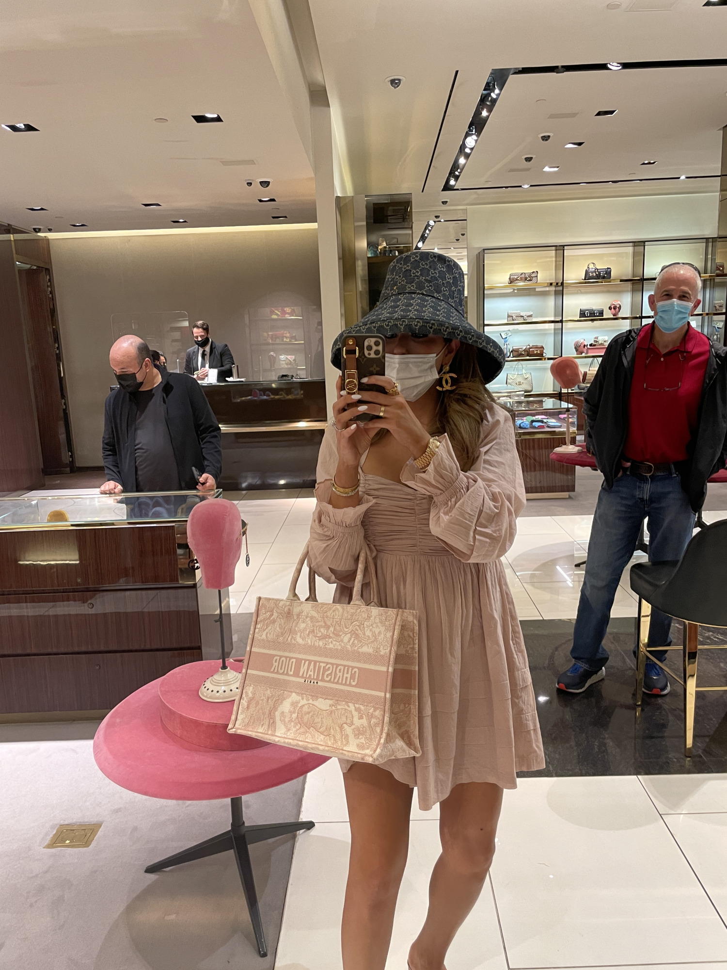 Instagram Recap by popular US life and style blog, The Sweetest Thing: image of Emily Gemma wearing a pink long sleeve mini dress, gold Chanel statement earrings, designer bucket hat, and holding a Christian Dior handbag. 