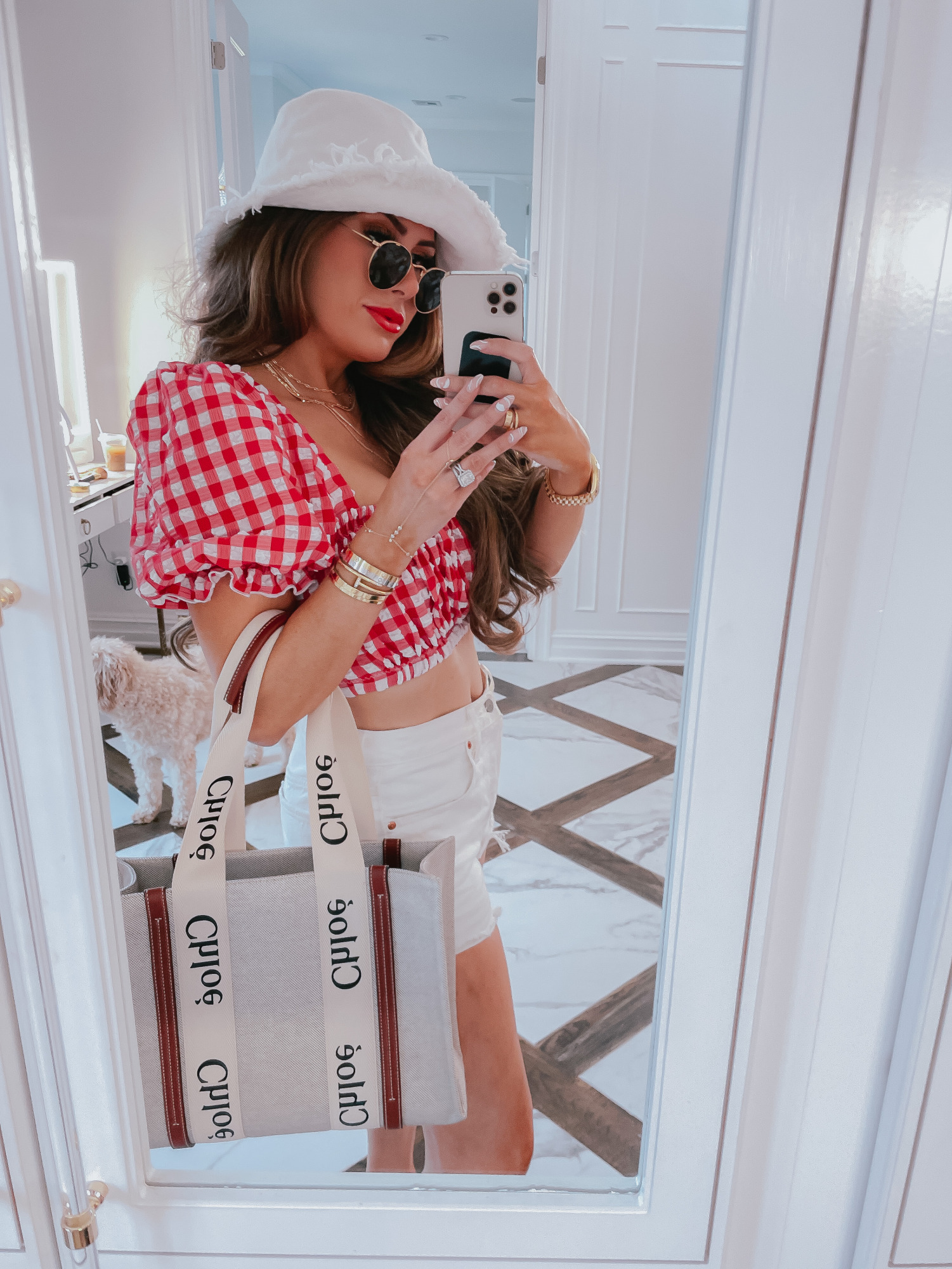 july 4 outfit inspiration 2021, pinterest july 4 outfit, bucket hat, gucci red lipstick, chloe tote bag, Emily gemma1 | 4th of July Outfits by popular US fashion blog, The Sweetest Thing: collage image of Emily Gemma wearing a white bucket hat, red and white gingham crop top, white jean shorts, sunglasses, gold bracelets, gold layer necklaces, and holding a Chloe bag. 