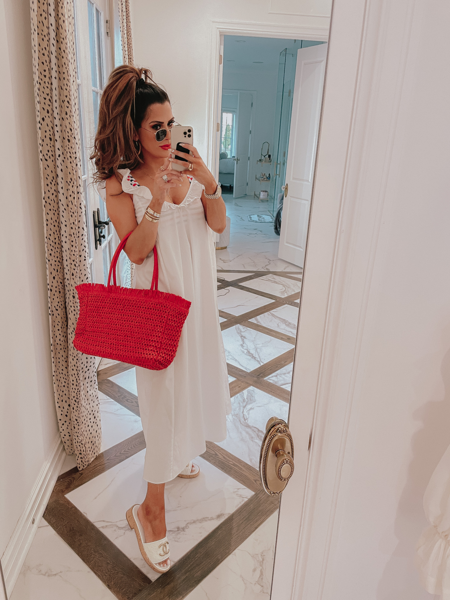 july 4 outfit inspiration 2021, pinterest july 4 outfit, gucci red lipstick goldie red, Emily gemma | June Instagram Recap by popular US fashion blog, The Sweetest Thing: image of Emily Gemma wearing a white maxi coverup, white sandals, and holding a red woven tote bag. 