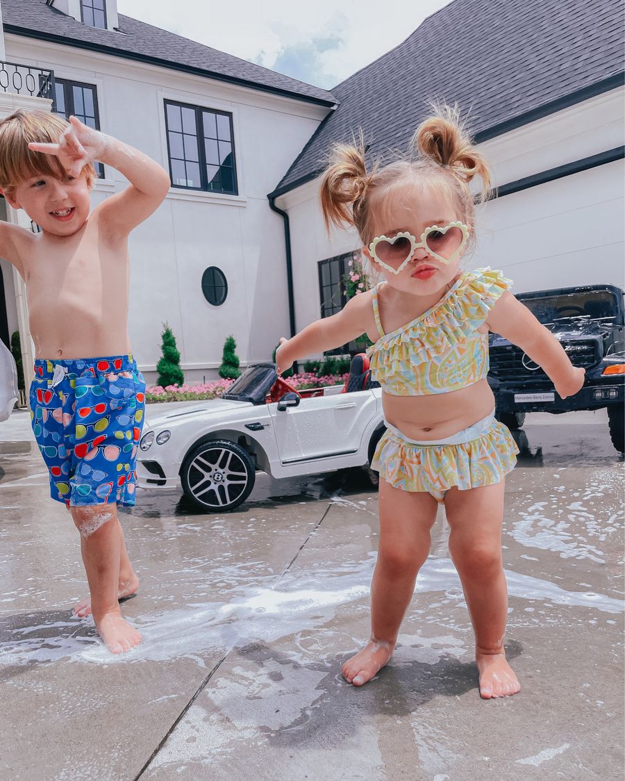 Luke and Sophia gemma, kids summer fun, little girl swimsuit, little girl sunglasses, little boy swimsuits, Emily ann gemma, Janie and jack | June Instagram Recap by popular US fashion blog, The Sweetest Thing: image of a young boy and girl wearing their swimsuits standing next to their mini cars.  