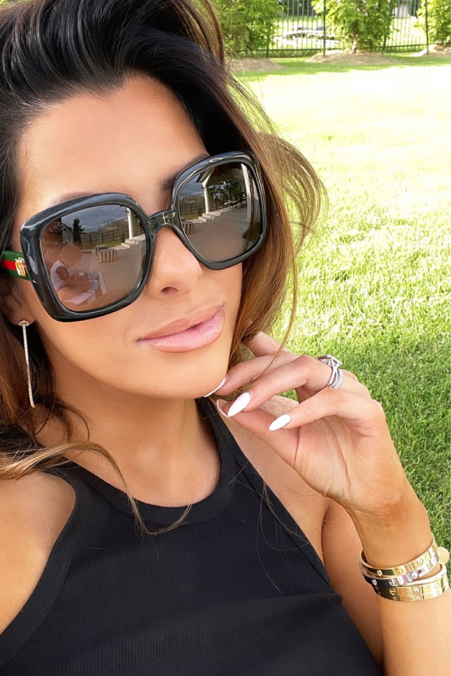 gucci sunglasses, best sunglasses spring 2021, emily ann gemma, casual outfit ideas summer 2021, best sunglasses summer 2021, nail inspiration, best gold hoop earrings summer 2021, Emily ann gemma lip combo | June Instagram Recap by popular US fashion blog, The Sweetest Thing: image of Emily Gemma wearing some black square frame sunglasses and a black tank. 