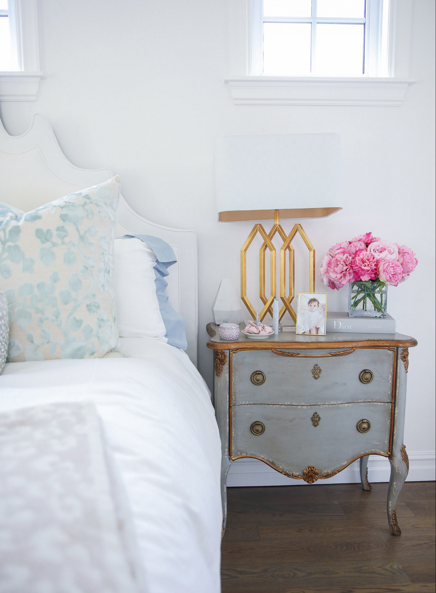 Instagram Recap by popular US life and style blog, The Sweetest Thing: image of a distressed grey dresser with a gold base lamp, acrylic picture frame and clear glass vase filled with pink peonies. 