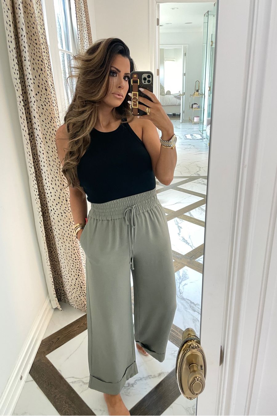 casual outfit ideas, best tank top summer 2021, tank tops under $30, best pants for warm weather, Emily ann gemma, casual outfit ideas summer 2021 | June Instagram Recap by popular US fashion blog, The Sweetest Thing: image of Emily Gemma wearing a black tank and grey wide leg drawstring pants. 